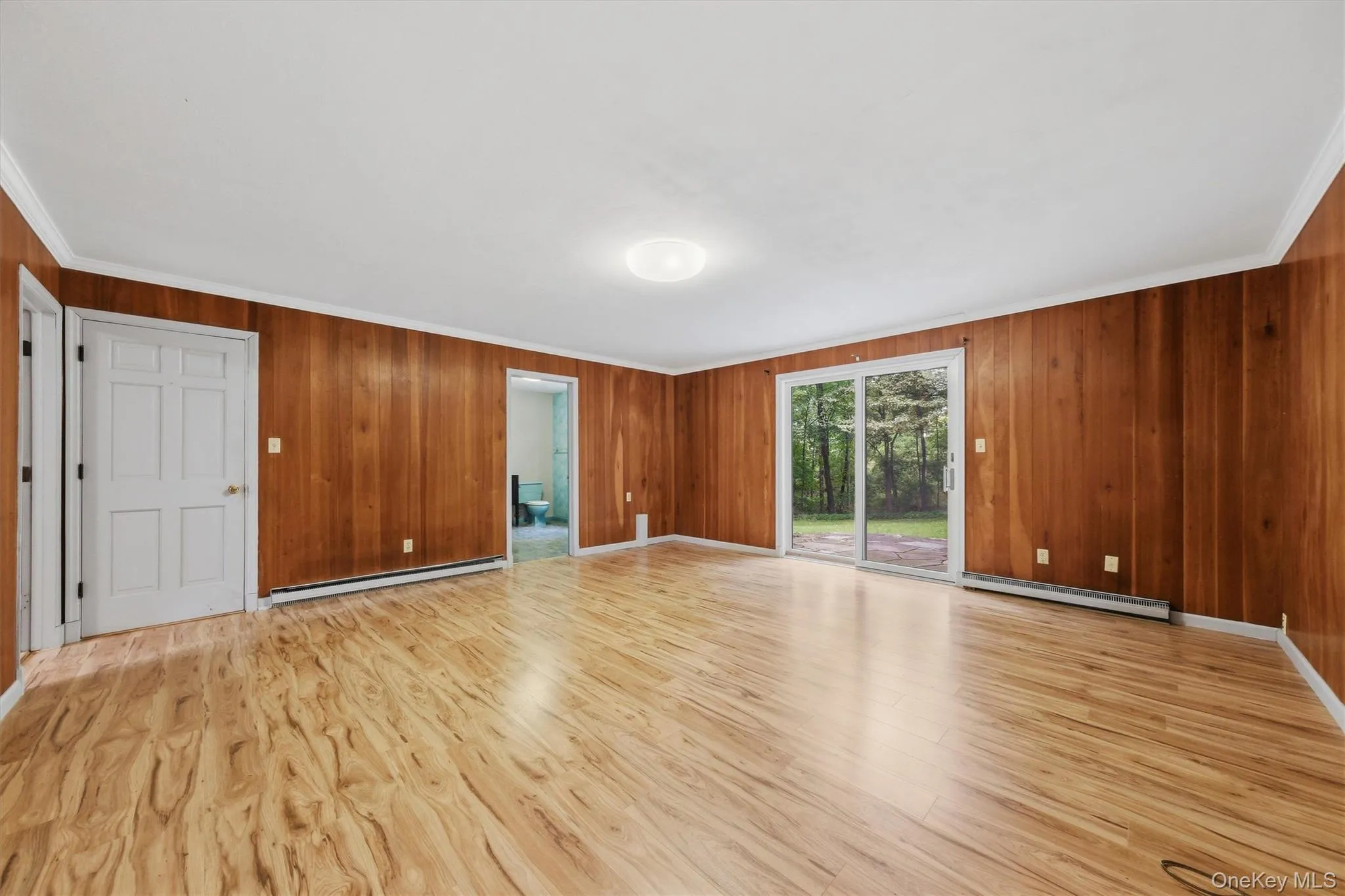 Enormous family room with new laminate floors and SGD to private backyard and patio Enormous family room with new laminate floors and SGD to private backyard and patio