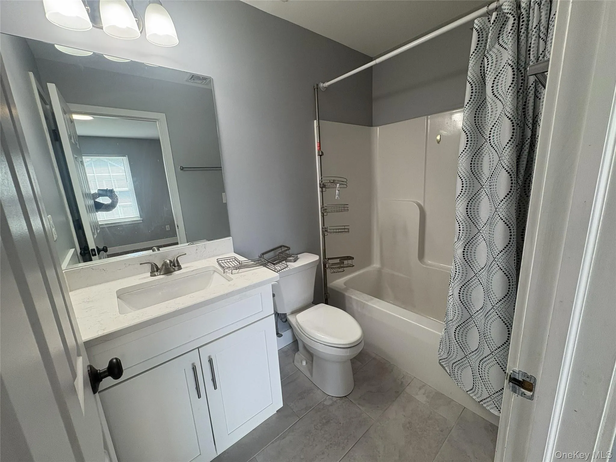 White vanity with a rectangular sink, a white countertop, and a chrome faucet White vanity with a rectangular sink, a white countertop, and a chrome faucet