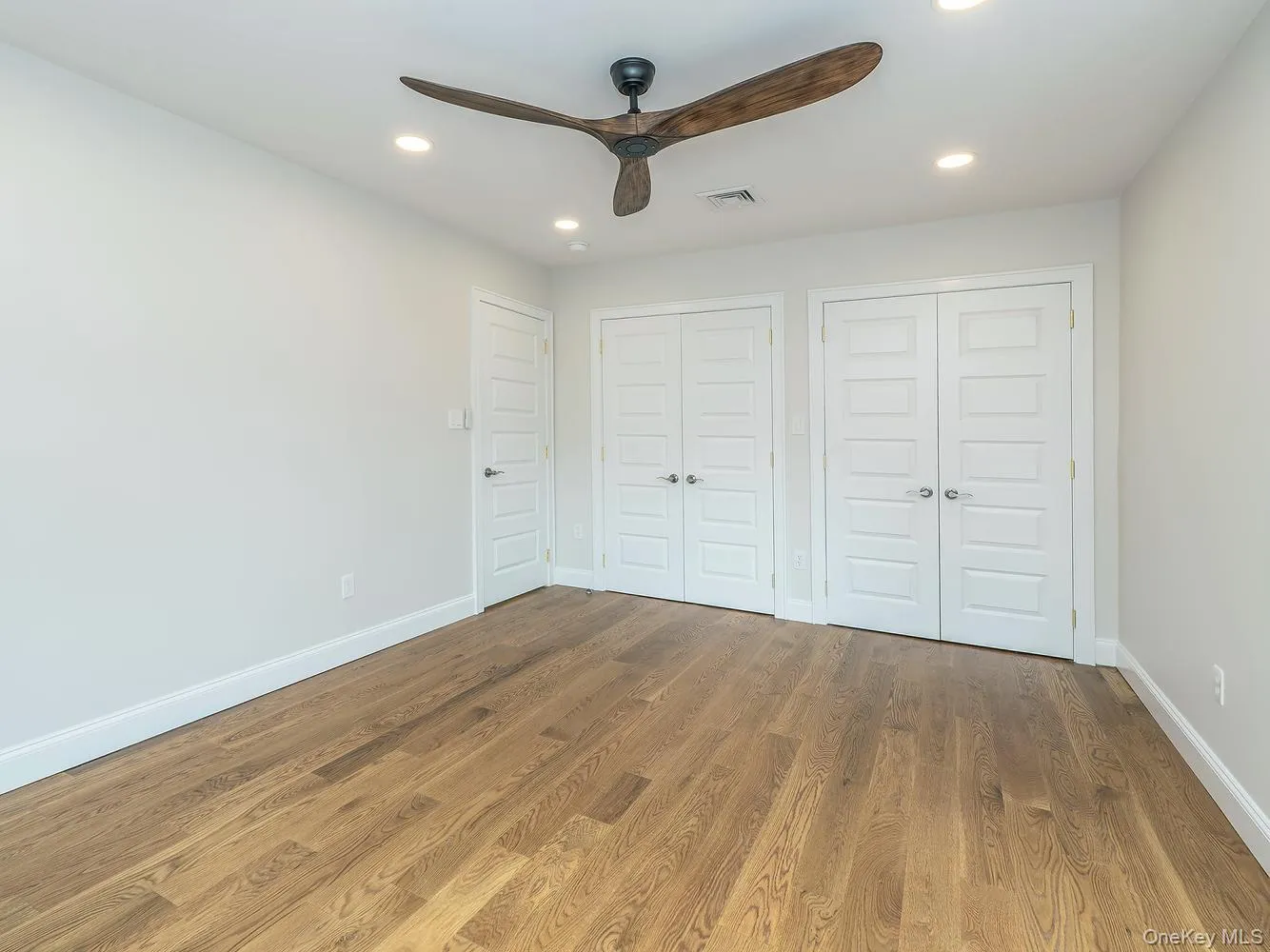 Primary bedroom on second floor with beautiful bay windows (seasonal water views) and double walk-in closets. Primary bedroom on second floor with beautiful bay windows (seasonal water views) and double walk-in closets.
