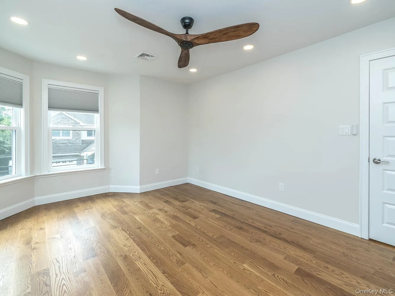 Primary bedroom on second floor with beautiful bay windows (seasonal water views) and double walk-in closets. Primary bedroom on second floor with beautiful bay windows (seasonal water views) and double walk-in closets.