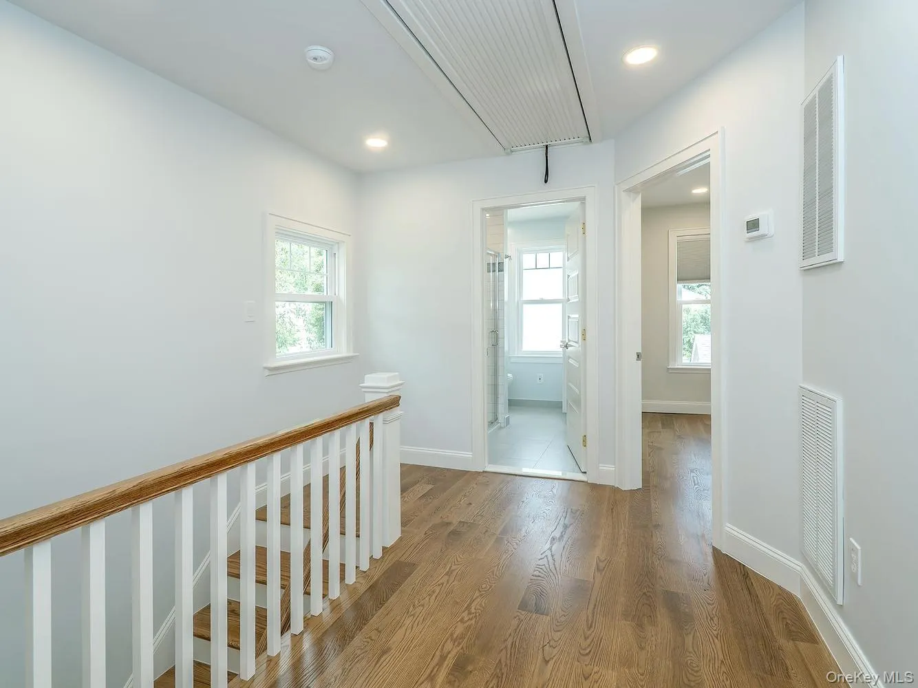 Hallway upstairs with 3 bedrooms and full bath. Pull down full attic above. Hallway upstairs with 3 bedrooms and full bath. Pull down full attic above.
