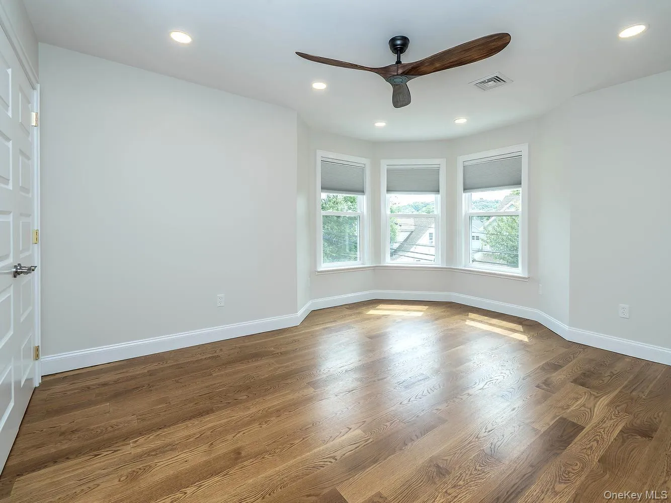 Primary bedroom on second floor with beautiful bay windows (seasonal water views) and double walk-in closets. Primary bedroom on second floor with beautiful bay windows (seasonal water views) and double walk-in closets.