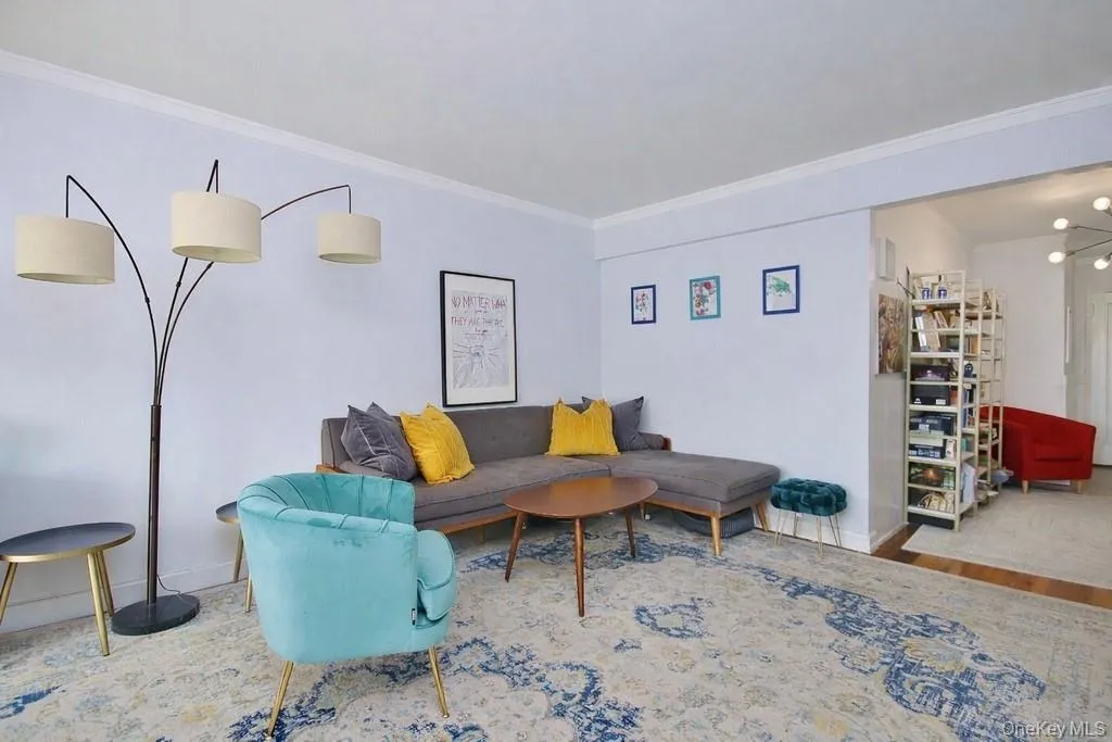 White walls with crown molding and wood-finish flooring White walls with crown molding and wood-finish flooring