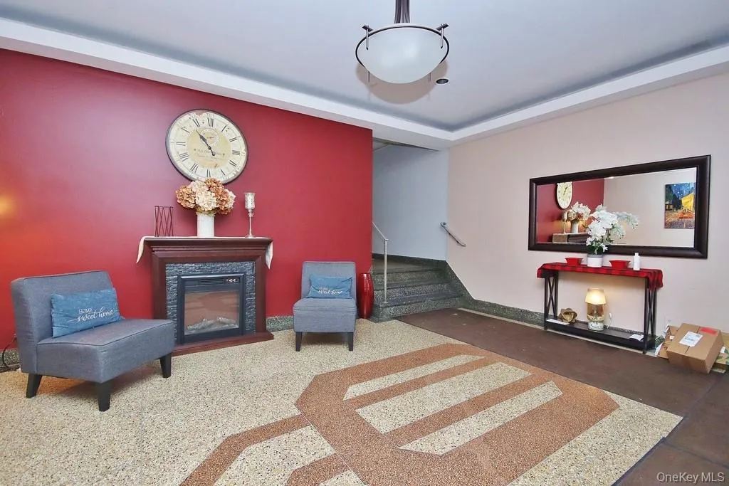 Decorative fireplace with a wood-finish mantel and stone-tile surround, complemented by a patterned terrazzo floor and a contemporary ceiling light fixture Decorative fireplace with a wood-finish mantel and stone-tile surround, complemented by a patterned terrazzo floor and a contemporary ceiling light fixture