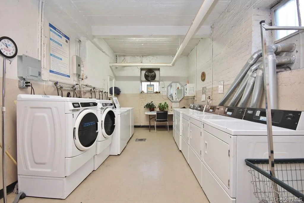 Laundry facility featuring multiple front-load washers, top-load washers, and commercial dryers Laundry facility featuring multiple front-load washers, top-load washers, and commercial dryers