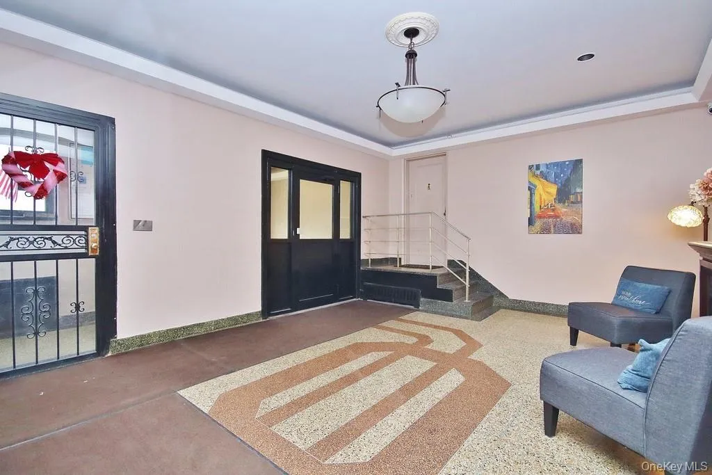 Terrazzo flooring with a geometric inlay design, recessed ceiling lighting, and a hanging pendant light fixture Terrazzo flooring with a geometric inlay design, recessed ceiling lighting, and a hanging pendant light fixture