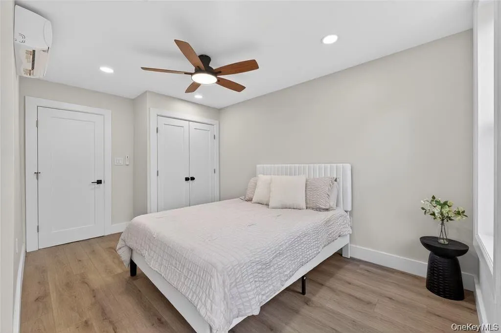 Wood-finish flooring, recessed lighting, and a sloped ceiling Wood-finish flooring, recessed lighting, and a sloped ceiling