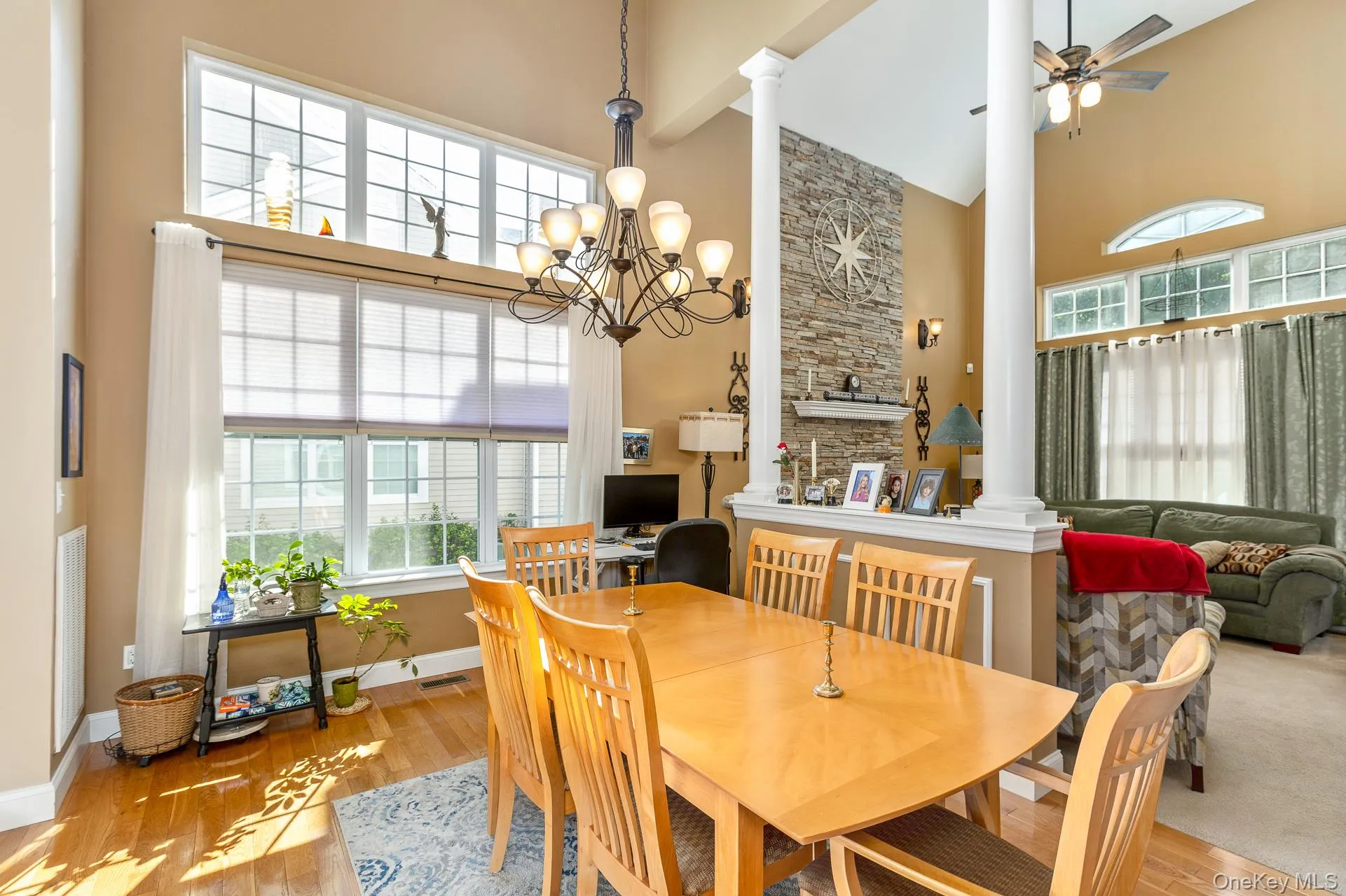 Open concept Dining area w/Vaulted ceilings, wood-finish flooring, floor-to-ceiling windows, and architectural columns Open concept Dining area w/Vaulted ceilings, wood-finish flooring, floor-to-ceiling windows, and architectural columns