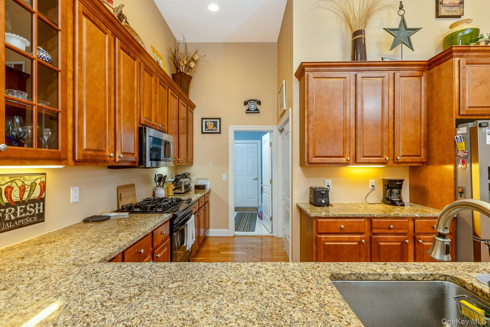 Fine Wood cabinetry, stainless steel appliances, undermount sink, and granite countertops Fine Wood cabinetry, stainless steel appliances, undermount sink, and granite countertops