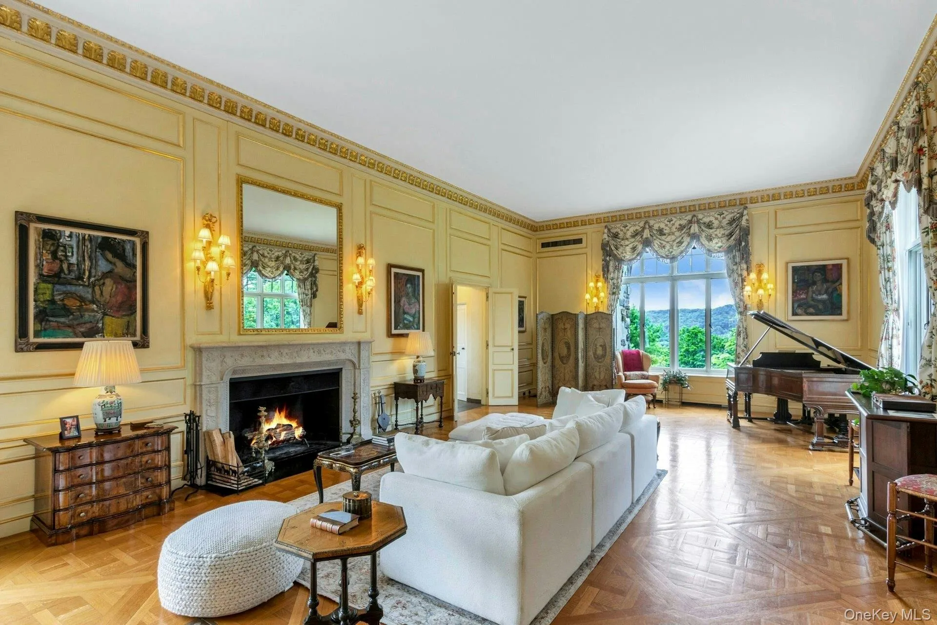 Living area featuring a decorative wall and a warm lit fireplace Living area featuring a decorative wall and a warm lit fireplace