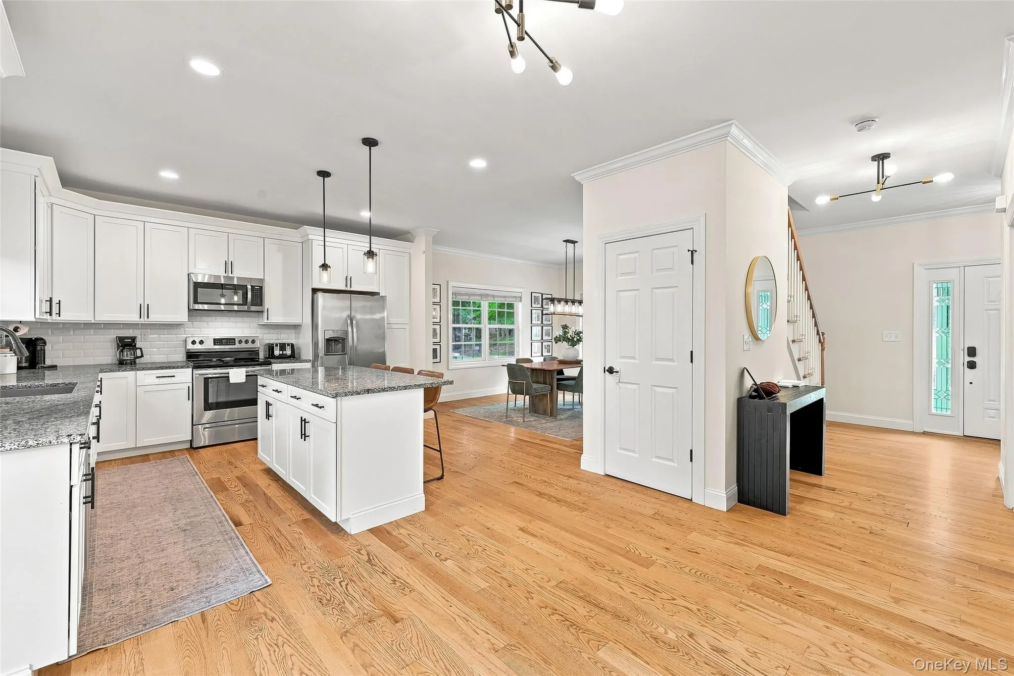 Open floor plan to kitchen with island and seating underneath Open floor plan to kitchen with island and seating underneath