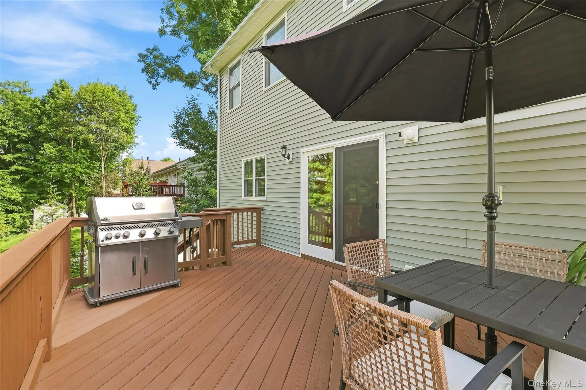 Sliding doors from kitchen to deck area with stairs leading to lower level Sliding doors from kitchen to deck area with stairs leading to lower level