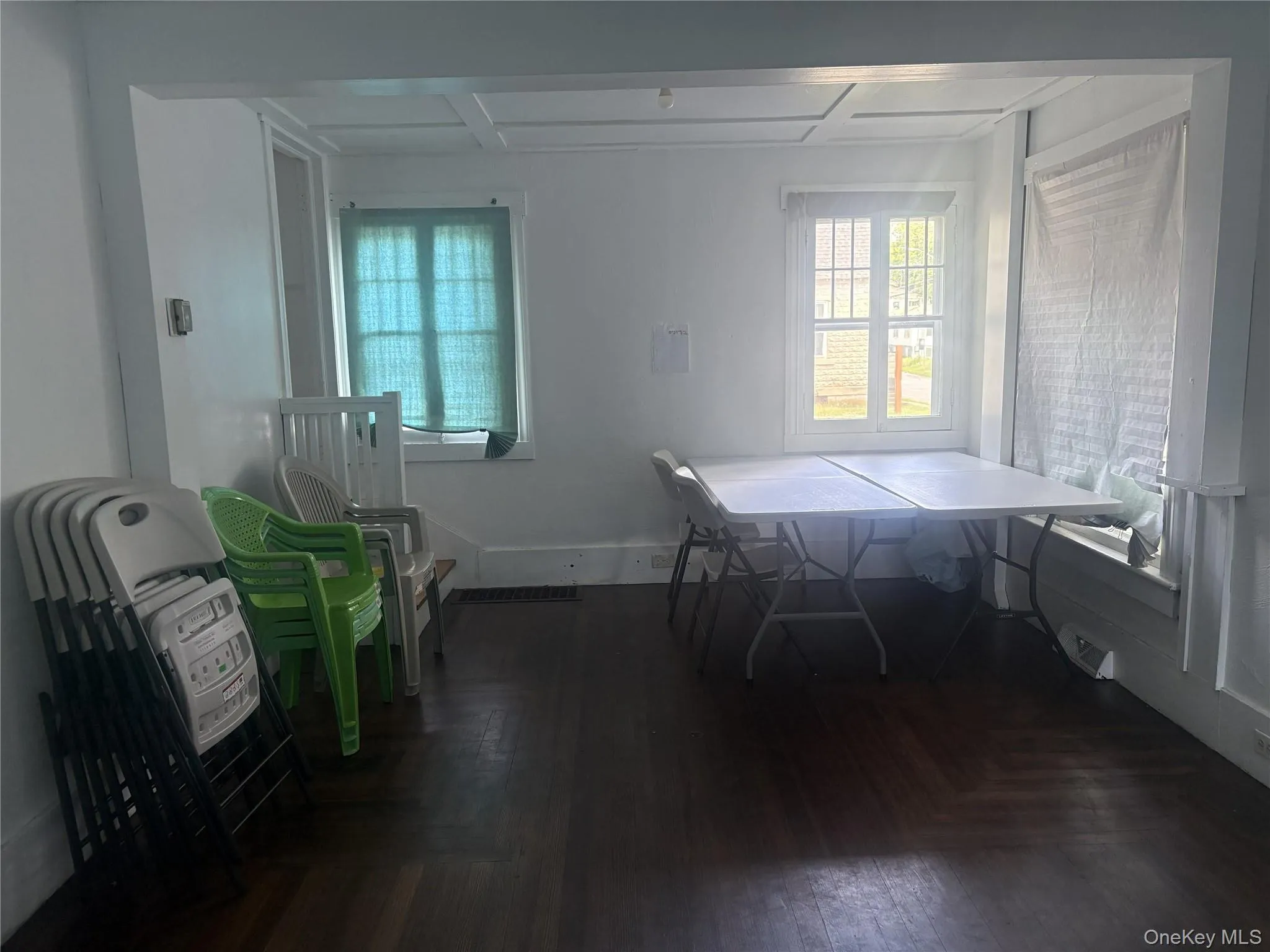 Hardwood flooring, painted white walls, white window trim, and a coffered ceiling Hardwood flooring, painted white walls, white window trim, and a coffered ceiling
