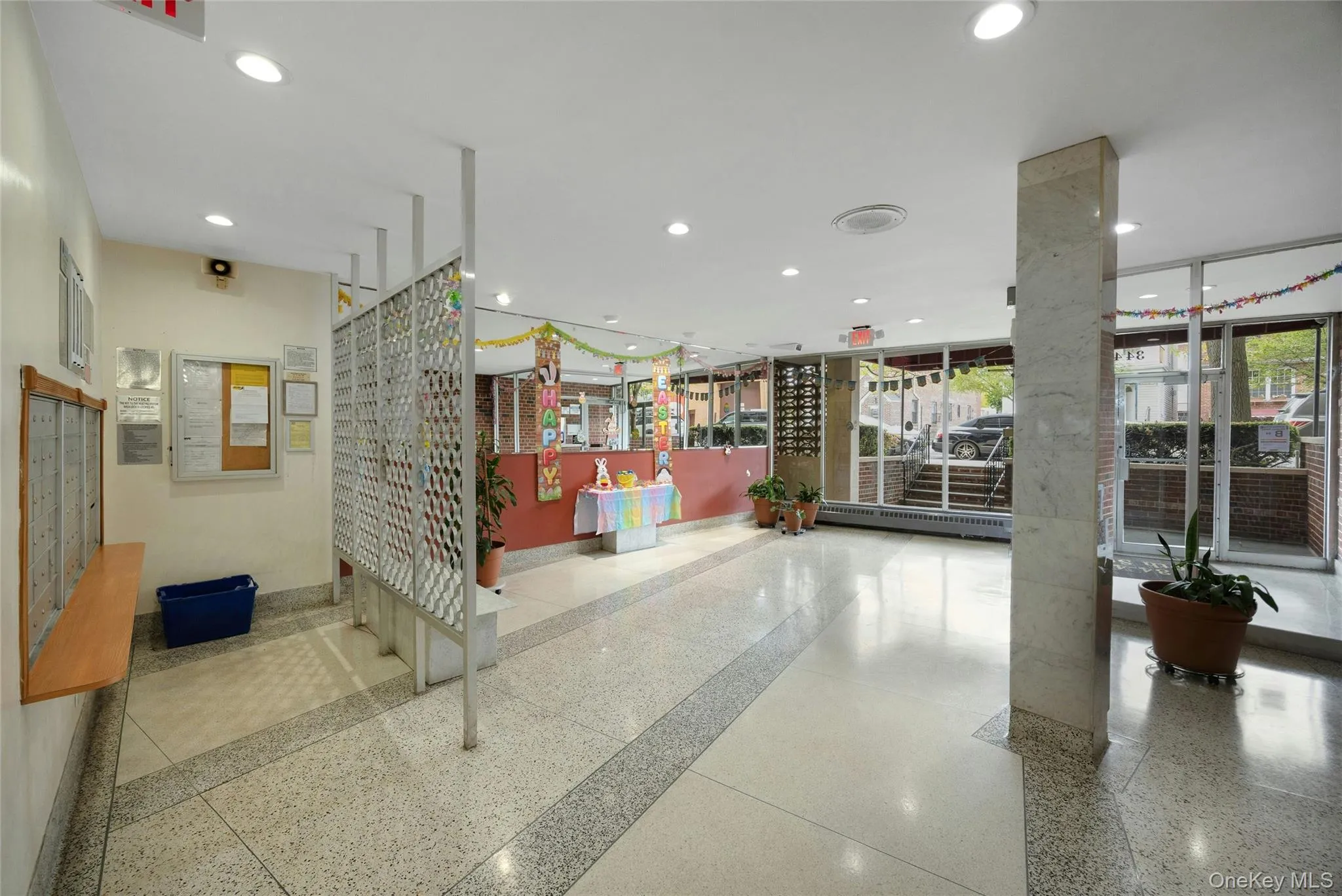 Spacious common area featuring patterned tile flooring, recessed lighting, a decorative room divider, and large windows Spacious common area featuring patterned tile flooring, recessed lighting, a decorative room divider, and large windows