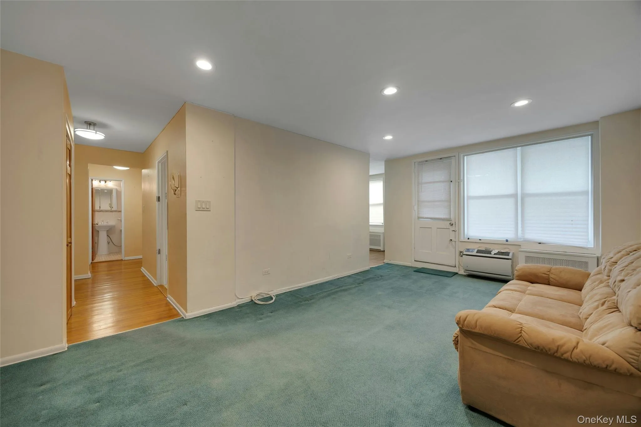Living area featuring recessed lighting and wall-to-wall carpeting Living area featuring recessed lighting and wall-to-wall carpeting