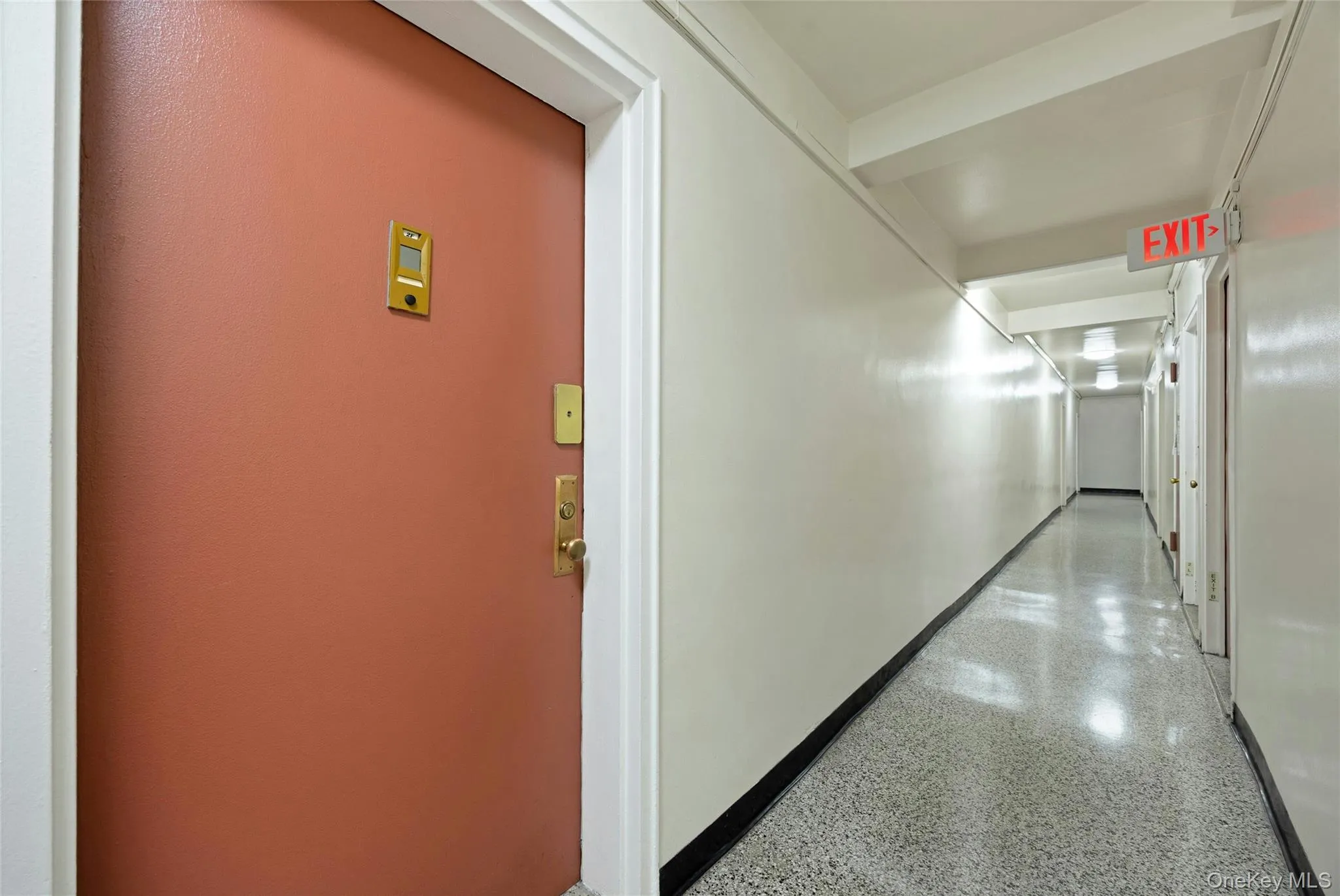 Entry door with a brass door handle and security viewer, framed by a white door casing Entry door with a brass door handle and security viewer, framed by a white door casing