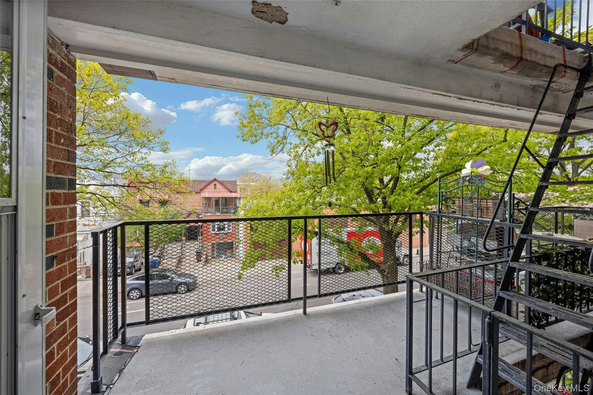 Concrete balcony with black metal railings, offering an open-air extension Concrete balcony with black metal railings, offering an open-air extension