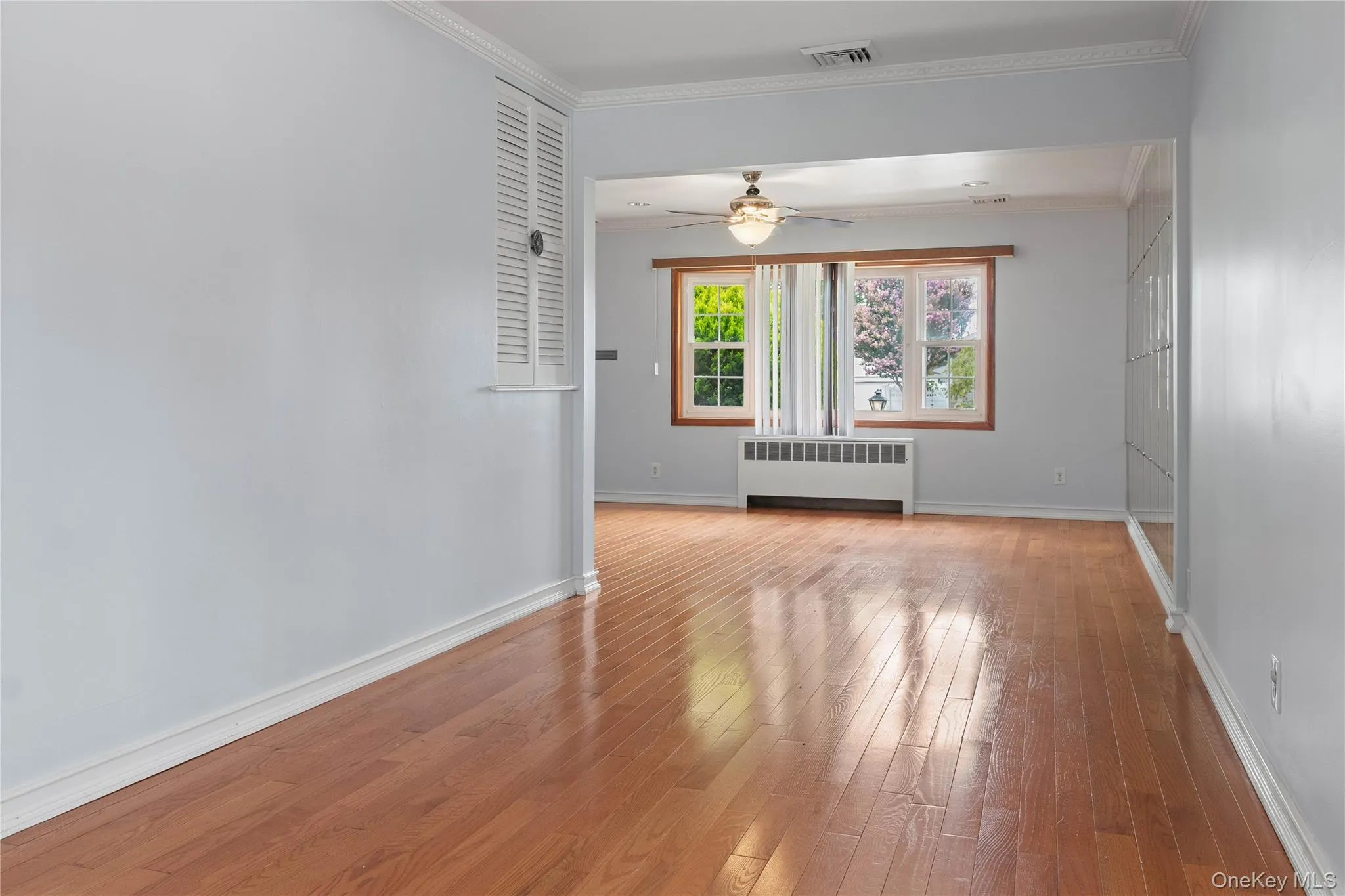 Formal Dining Room with Hardwood flooring, crown molding, and a louvered closet door Formal Dining Room with Hardwood flooring, crown molding, and a louvered closet door