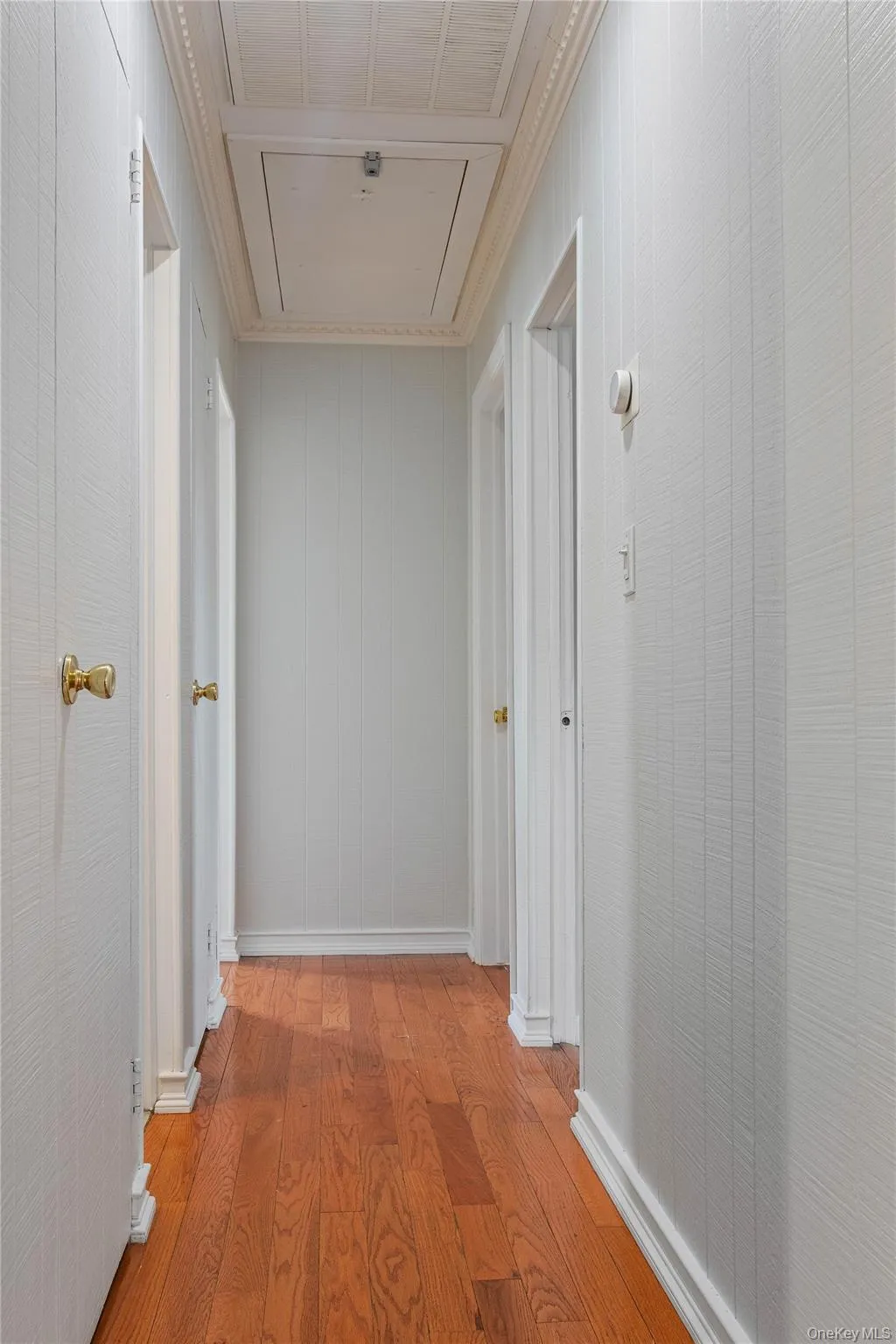 First Floor Hallway to 3 Bedrooms, 1st Full Bathroom, Linen Closet, and Access to Attic Storage Space First Floor Hallway to 3 Bedrooms, 1st Full Bathroom, Linen Closet, and Access to Attic Storage Space