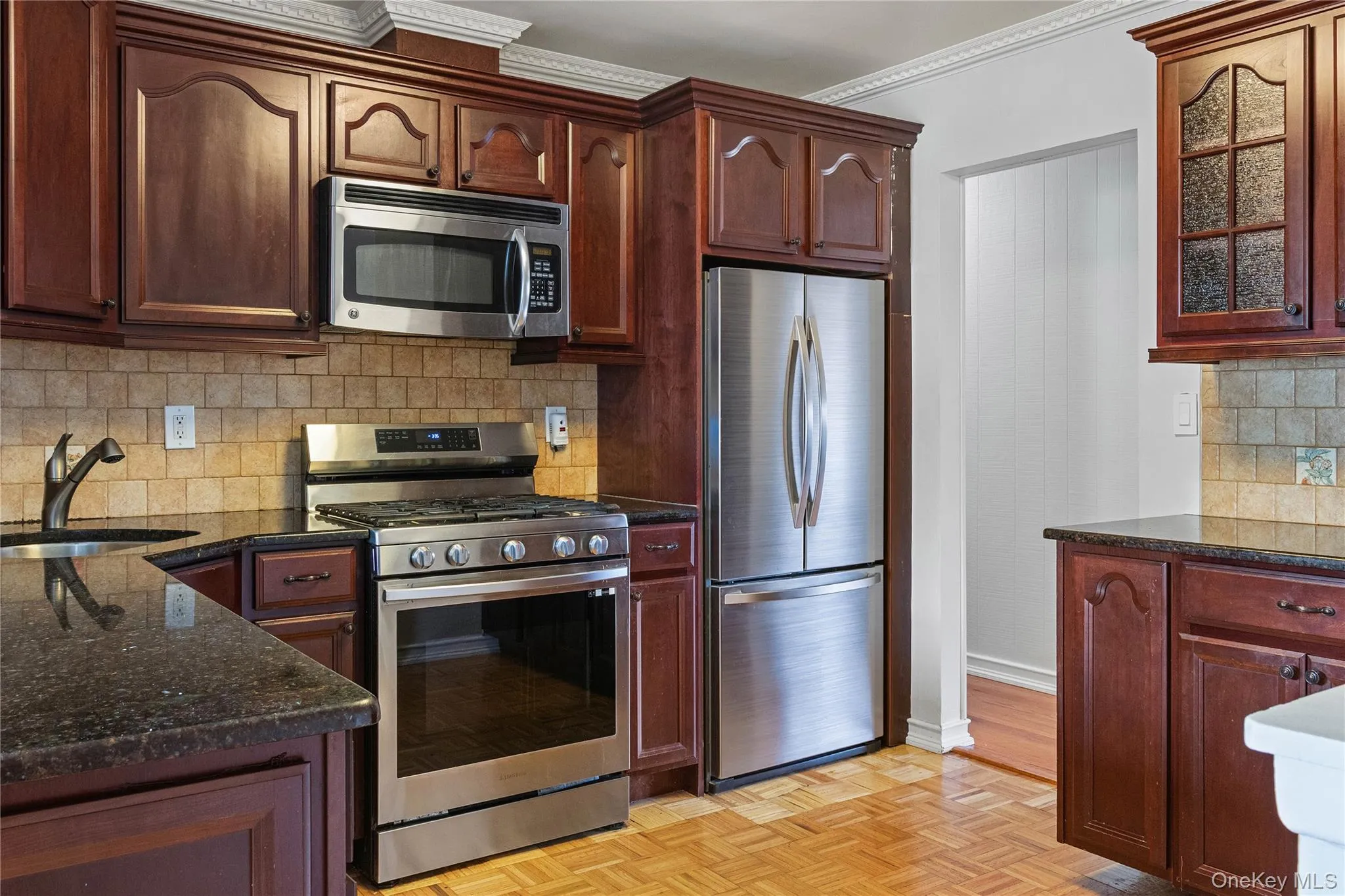 Spacious Kitchen with Granite Countertops and Peninsula with Stainless Steel Gas Cooking Range, Dishwasher, and Microwave Spacious Kitchen with Granite Countertops and Peninsula with Stainless Steel Gas Cooking Range, Dishwasher, and Microwave