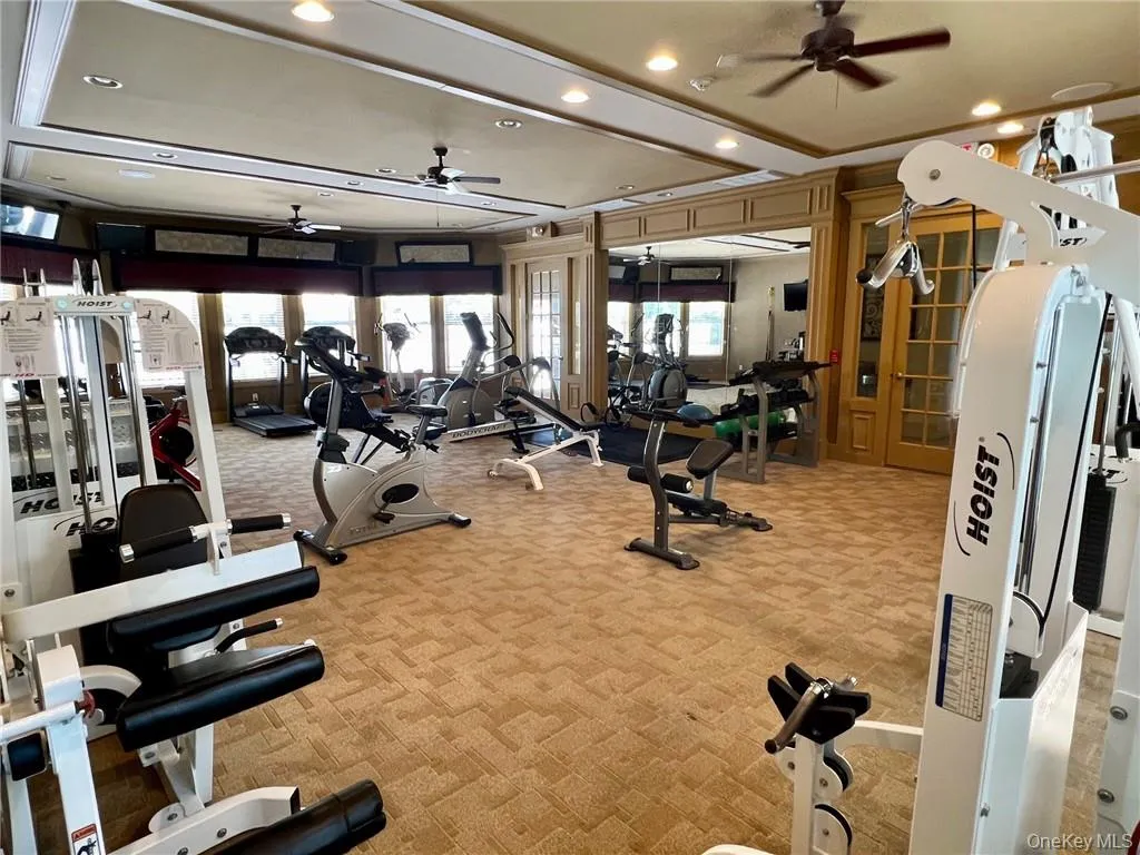 Gym with ceiling fan and light colored carpet Gym with ceiling fan and light colored carpet