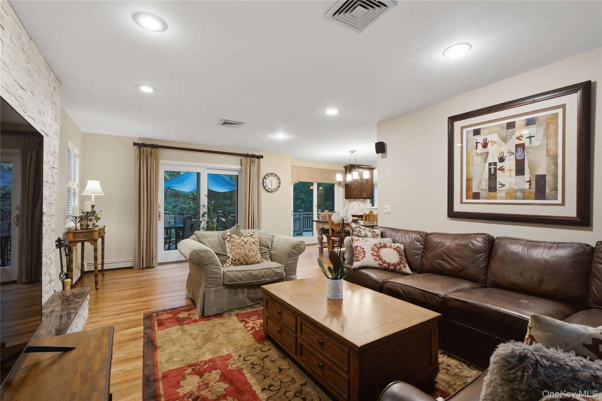 The Den with Stone-Faced Wood-Burning Fireplace, and Sliders to the Private Deck and Scenic Outdoors, is also Opened to the Gourmet Kitchen. The Den with Stone-Faced Wood-Burning Fireplace, and Sliders to the Private Deck and Scenic Outdoors, is also Opened to the Gourmet Kitchen.