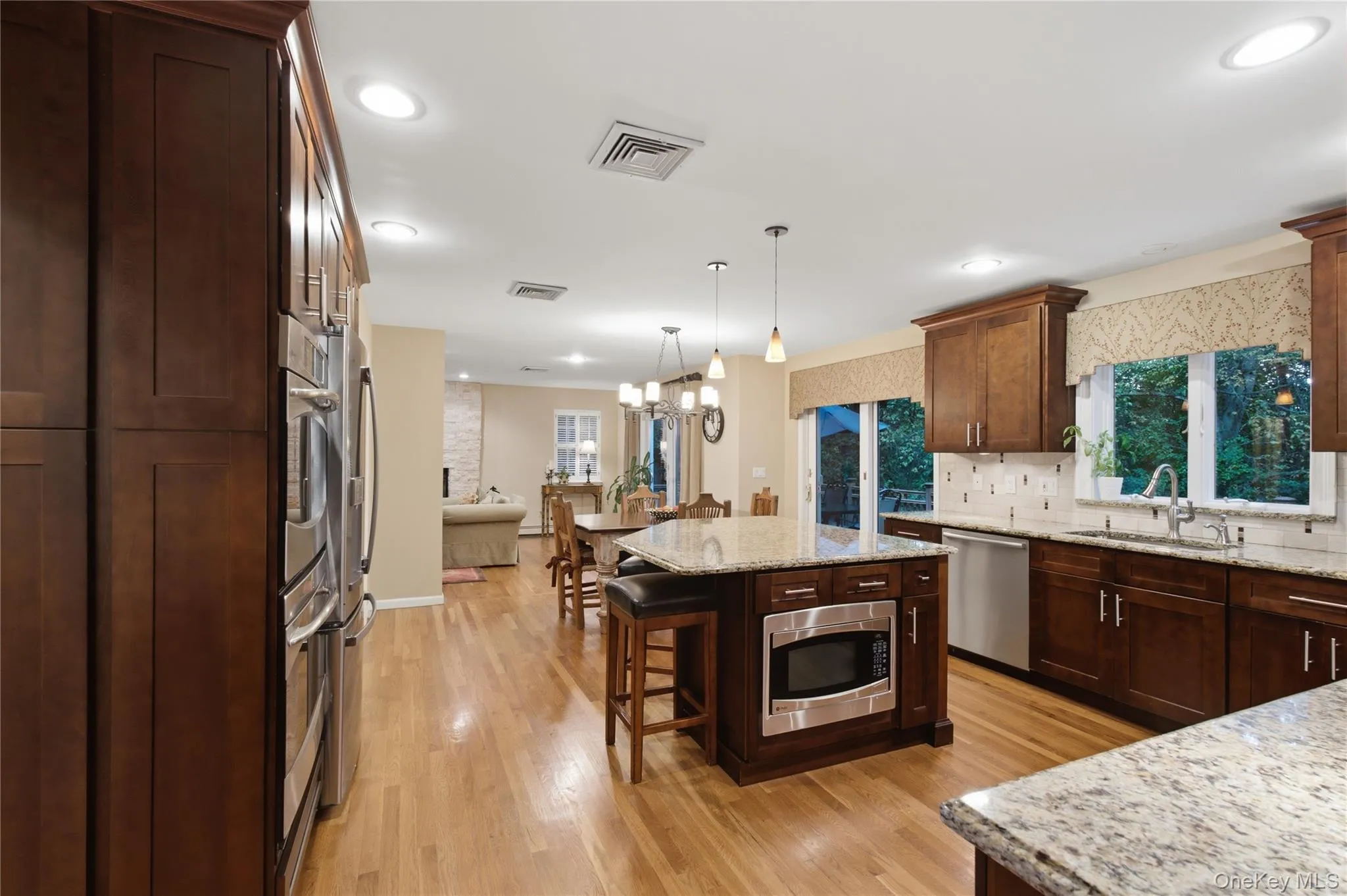 The gourmet kitchen is truly the heart of the home, thoughtfully designed with granite countertops, generous space for cooking, gathering and entertaining, along with abundant storage. The gourmet kitchen is truly the heart of the home, thoughtfully designed with granite countertops, generous space for cooking, gathering and entertaining, along with abundant storage.