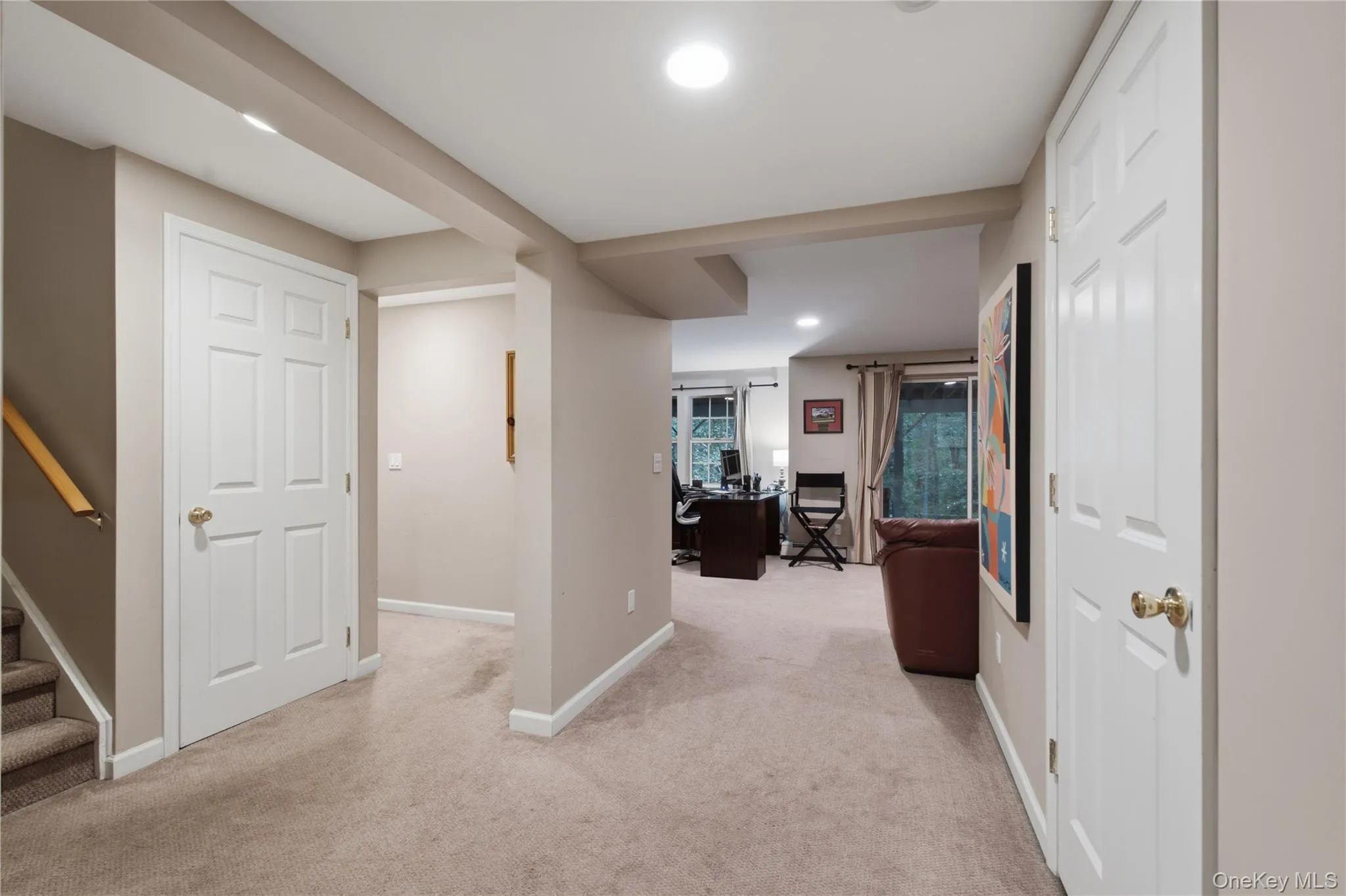 Versatile Lower-Level Space offers Multiple Multipurpose Rooms, Currently enjoyed as a Home Office, Recreation Area with Sliders to the Outdoors, and Dedicated Workout Area. Separate Storage and Utility Rooms with Access to the 2-Car Garage. Versatile Lower-Level Space offers Multiple Multipurpose Rooms, Currently enjoyed as a Home Office, Recreation Area with Sliders to the Outdoors, and Dedicated Workout Area. Separate Storage and Utility Rooms with Access to the 2-Car Garage.