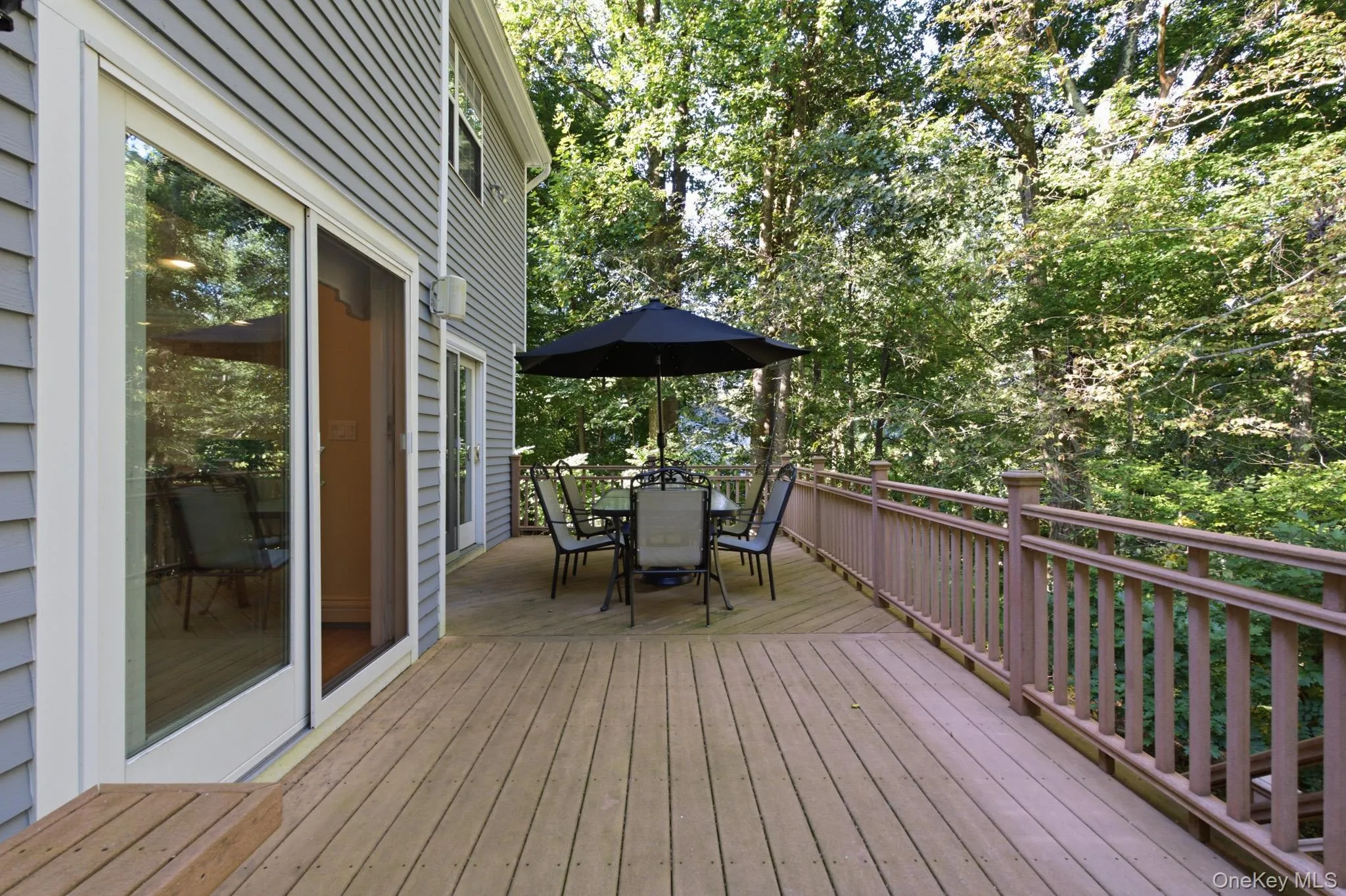 Extend your Entertaining and Relaxation Outdoors on the Expansive Trex Deck, Conveniently Accessible from both the Den and Kitchen, and Stairway to the Backyard. Extend your Entertaining and Relaxation Outdoors on the Expansive Trex Deck, Conveniently Accessible from both the Den and Kitchen, and Stairway to the Backyard.
