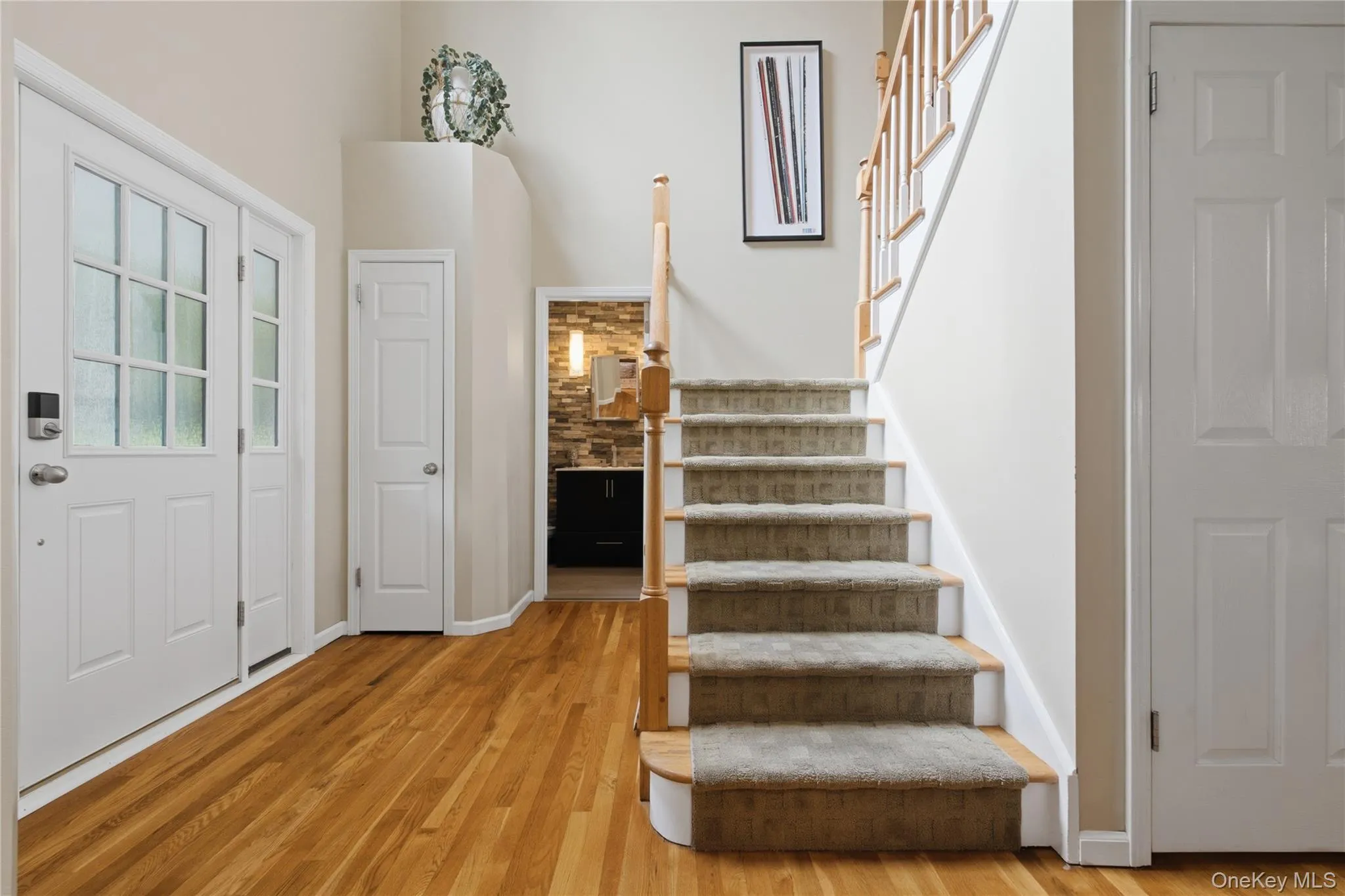 A dramatic double-height ceiling greets you with grandeur, creating an impressive sense of arrival while seamlessly connecting the home’s inviting entertaining spaces. A dramatic double-height ceiling greets you with grandeur, creating an impressive sense of arrival while seamlessly connecting the home’s inviting entertaining spaces.