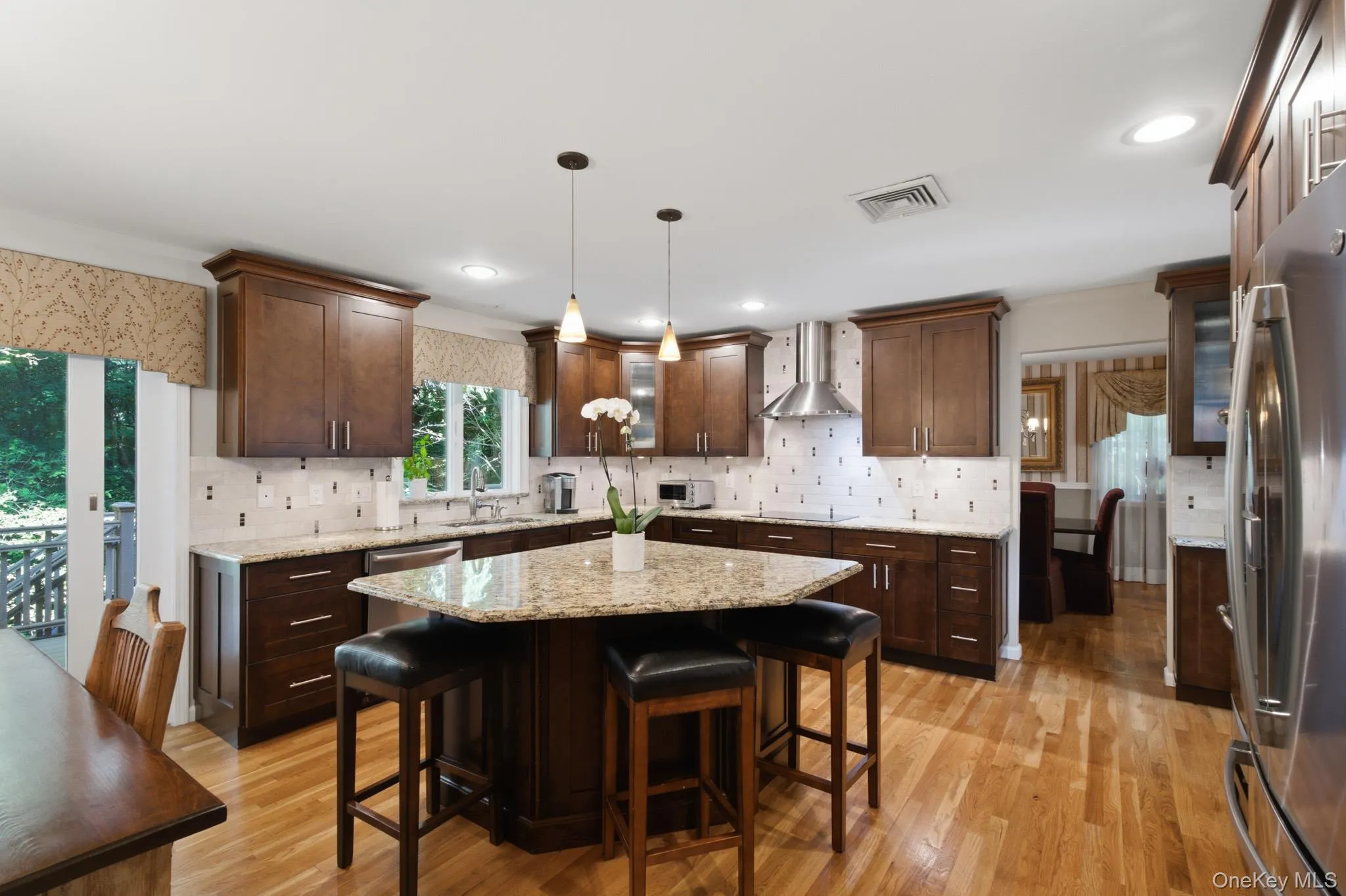 Expansive granite center island with generous seating—perfect for gathering, dining, and entertaining. Expansive granite center island with generous seating—perfect for gathering, dining, and entertaining.
