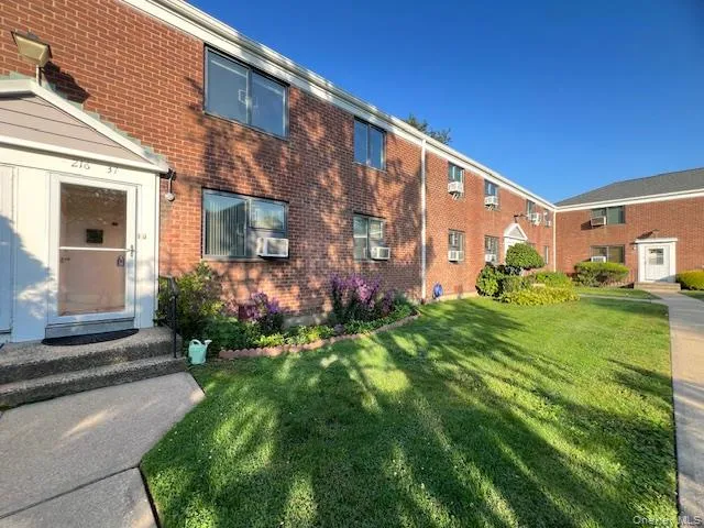 View of front of house featuring a front yard and brick siding View of front of house featuring a front yard and brick siding