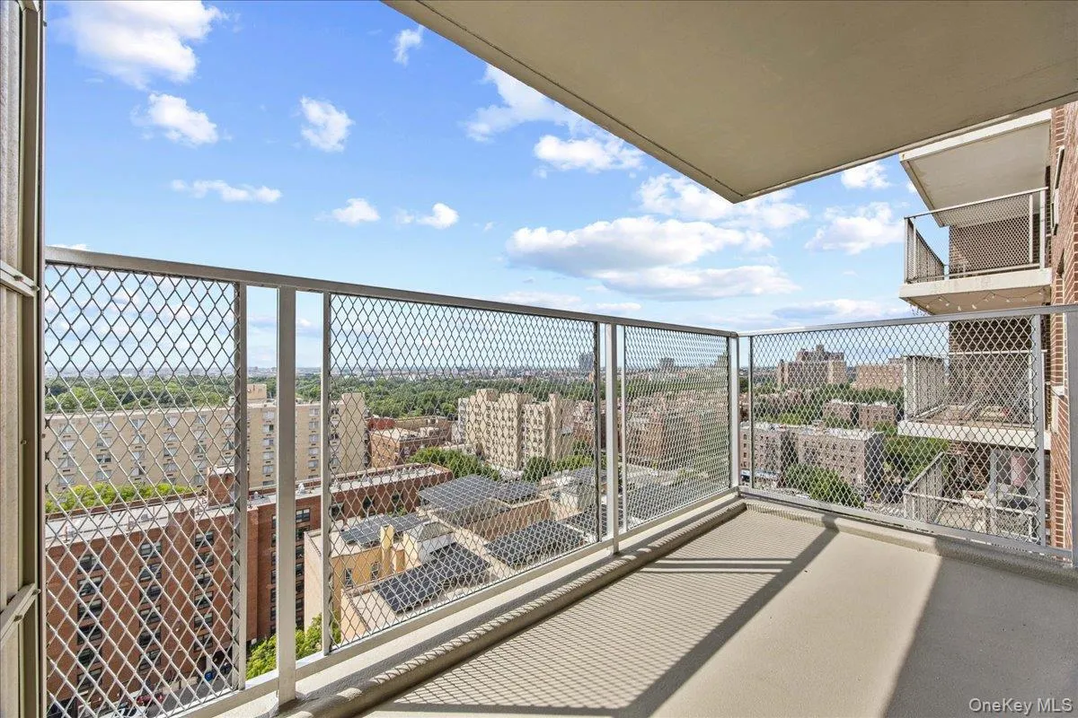 Private balcony with a concrete floor and metal mesh railing Private balcony with a concrete floor and metal mesh railing