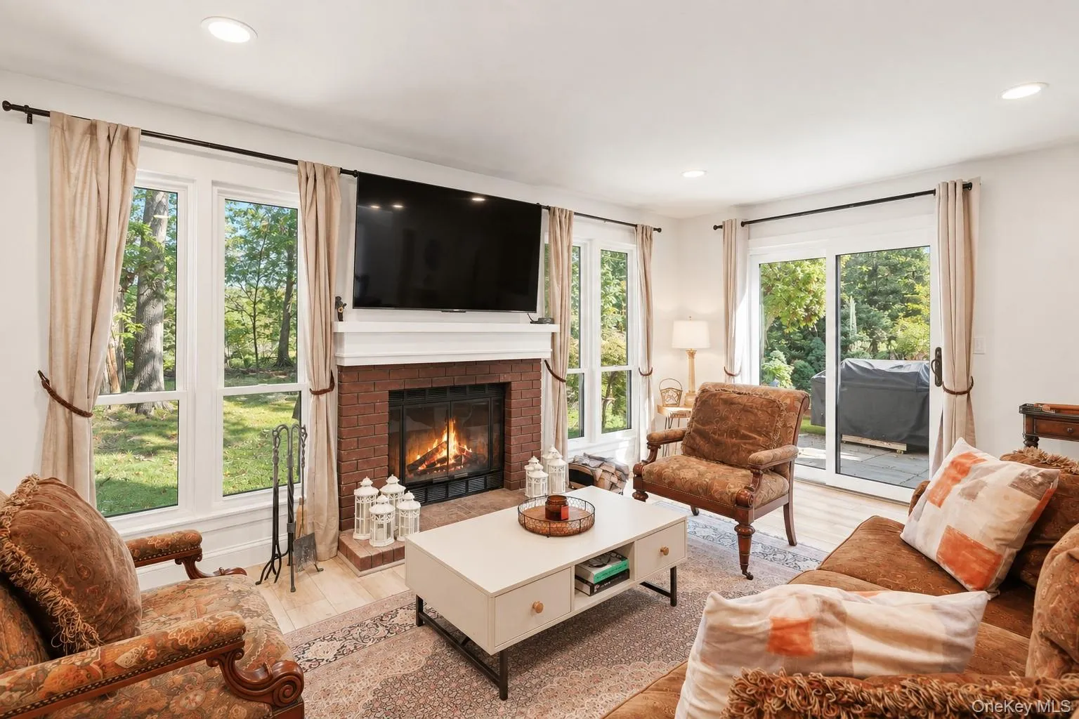 Living Room with Wood Burning Fireplace and Glass Doors to Patio Living Room with Wood Burning Fireplace and Glass Doors to Patio