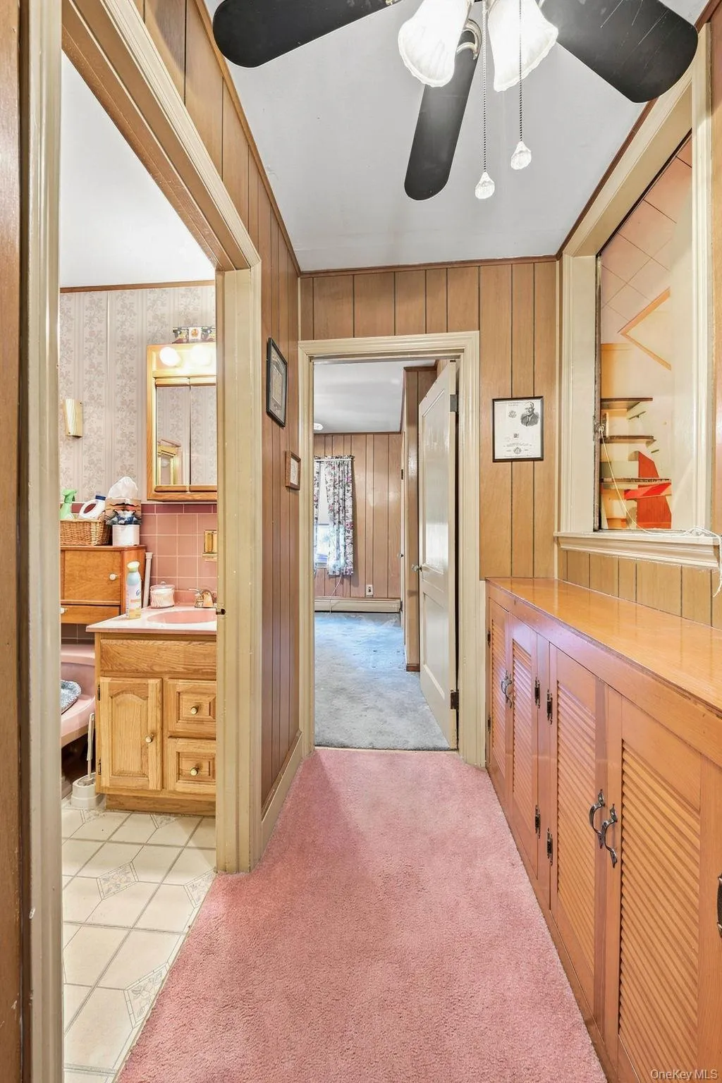 paneled walls, wall to wall carpet leading to bedrooms, bathroom and attic paneled walls, wall to wall carpet leading to bedrooms, bathroom and attic