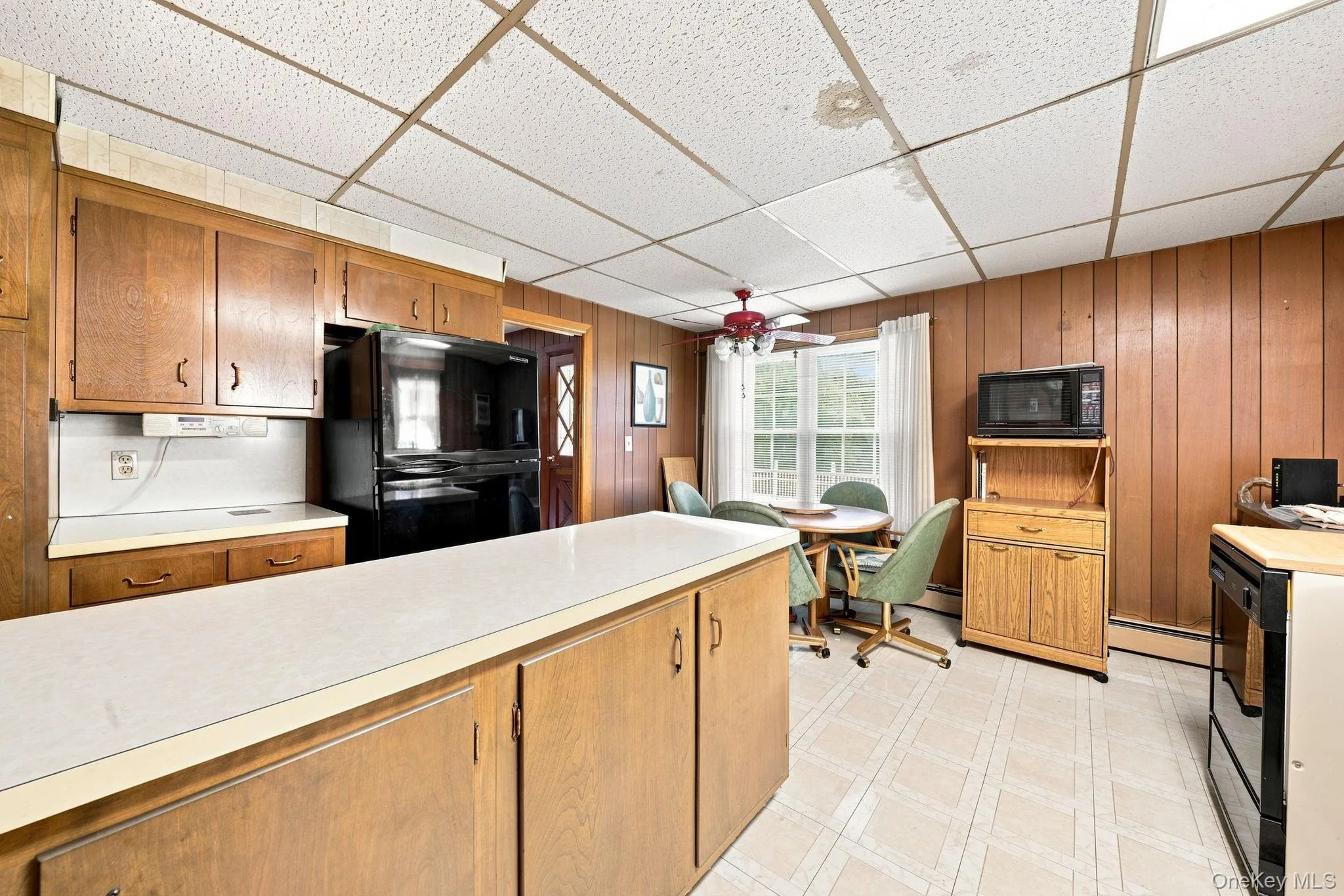 Spacious kitchen with long island, eating area with fan/light and microwave station Spacious kitchen with long island, eating area with fan/light and microwave station