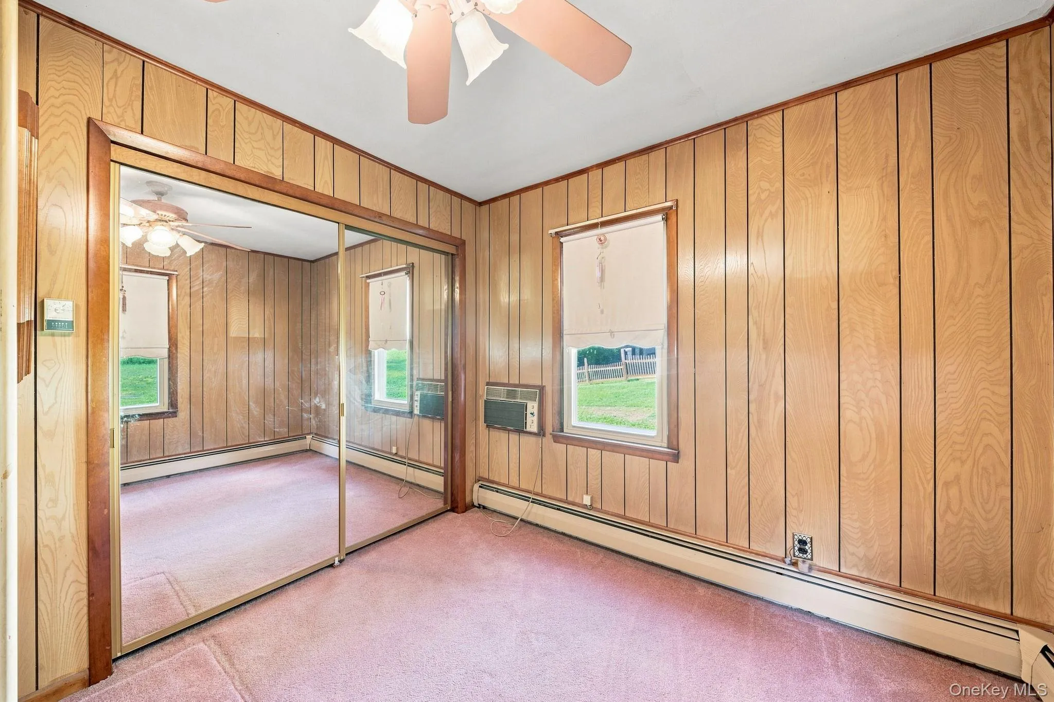 paneled walls, full glass closet doors, wall to wall carpet, ceiling fan/light paneled walls, full glass closet doors, wall to wall carpet, ceiling fan/light