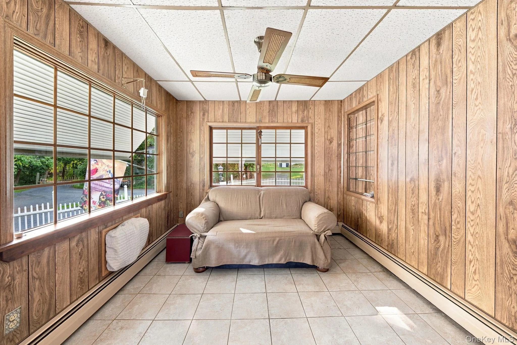 paneled walls and large windows all around, fan, built-in cabinet paneled walls and large windows all around, fan, built-in cabinet