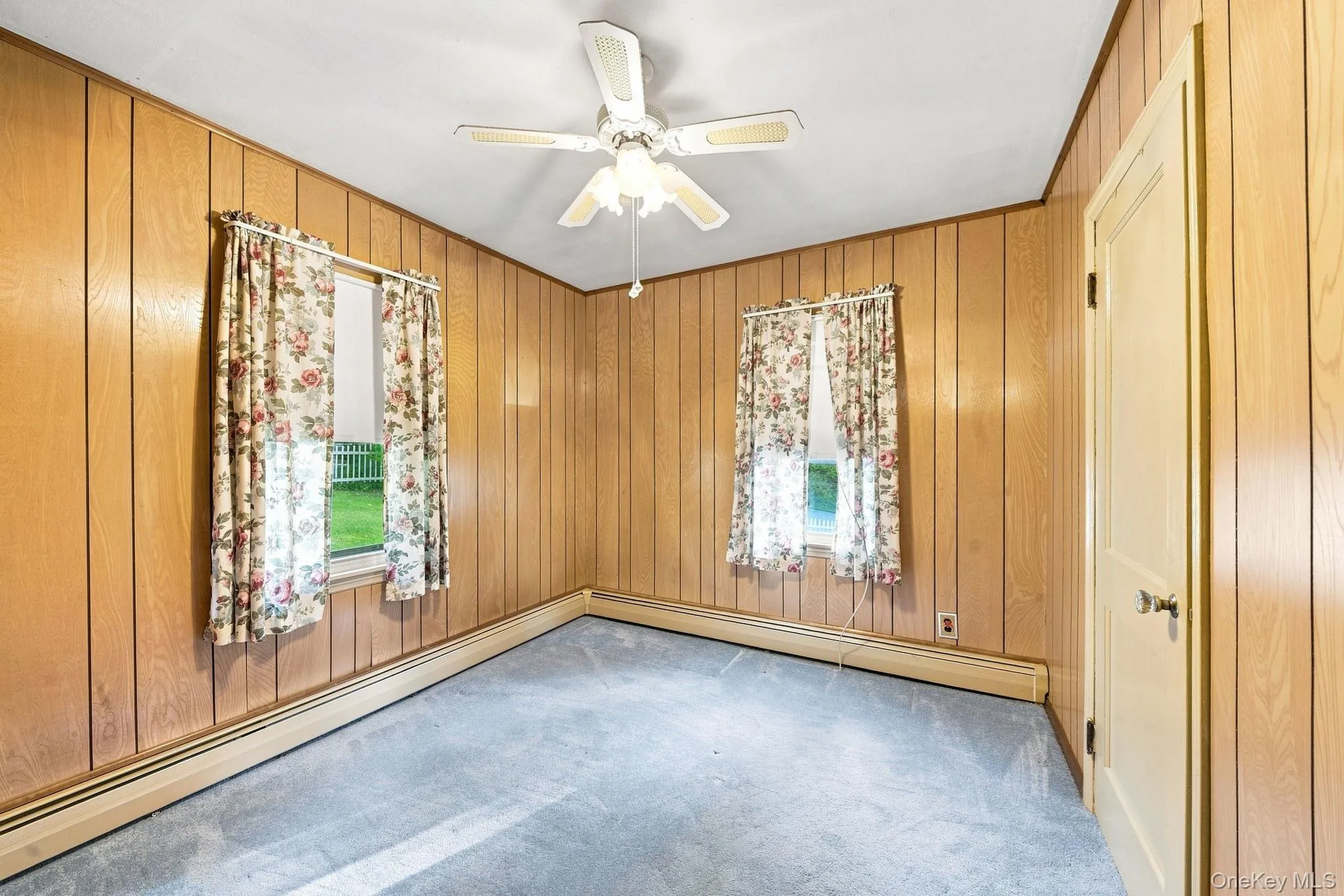 paneled walls, two windows, closet, like-new wall to wall carpet, ceiling fan/light paneled walls, two windows, closet, like-new wall to wall carpet, ceiling fan/light