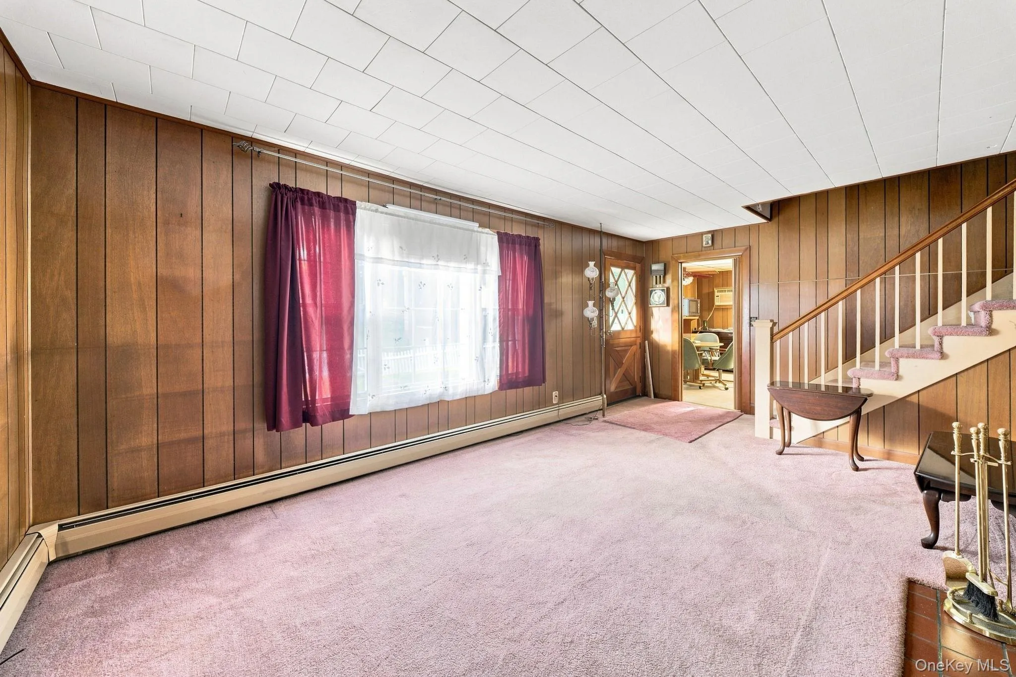 Wood-paneled walls, brick fireplace and short stairway to bedrooms Wood-paneled walls, brick fireplace and short stairway to bedrooms