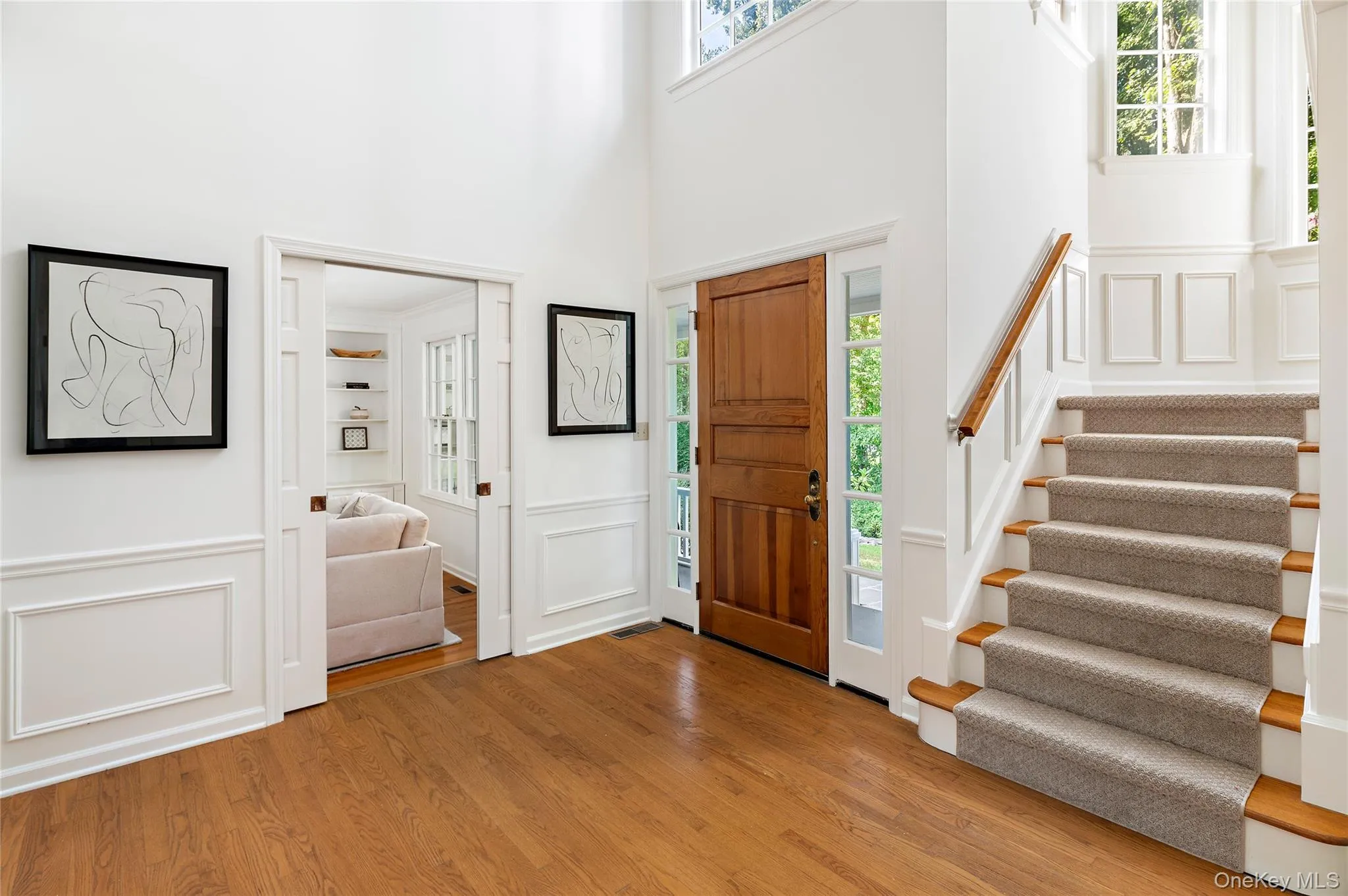 Generous foyer with pocket doors to family room, multiple windows and the unique turret with staircase to second floor Generous foyer with pocket doors to family room, multiple windows and the unique turret with staircase to second floor