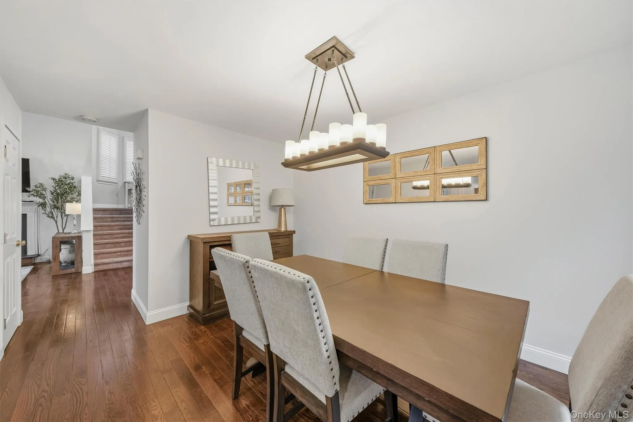 Hardwood flooring throughout, and a modern rectangular chandelier Hardwood flooring throughout, and a modern rectangular chandelier