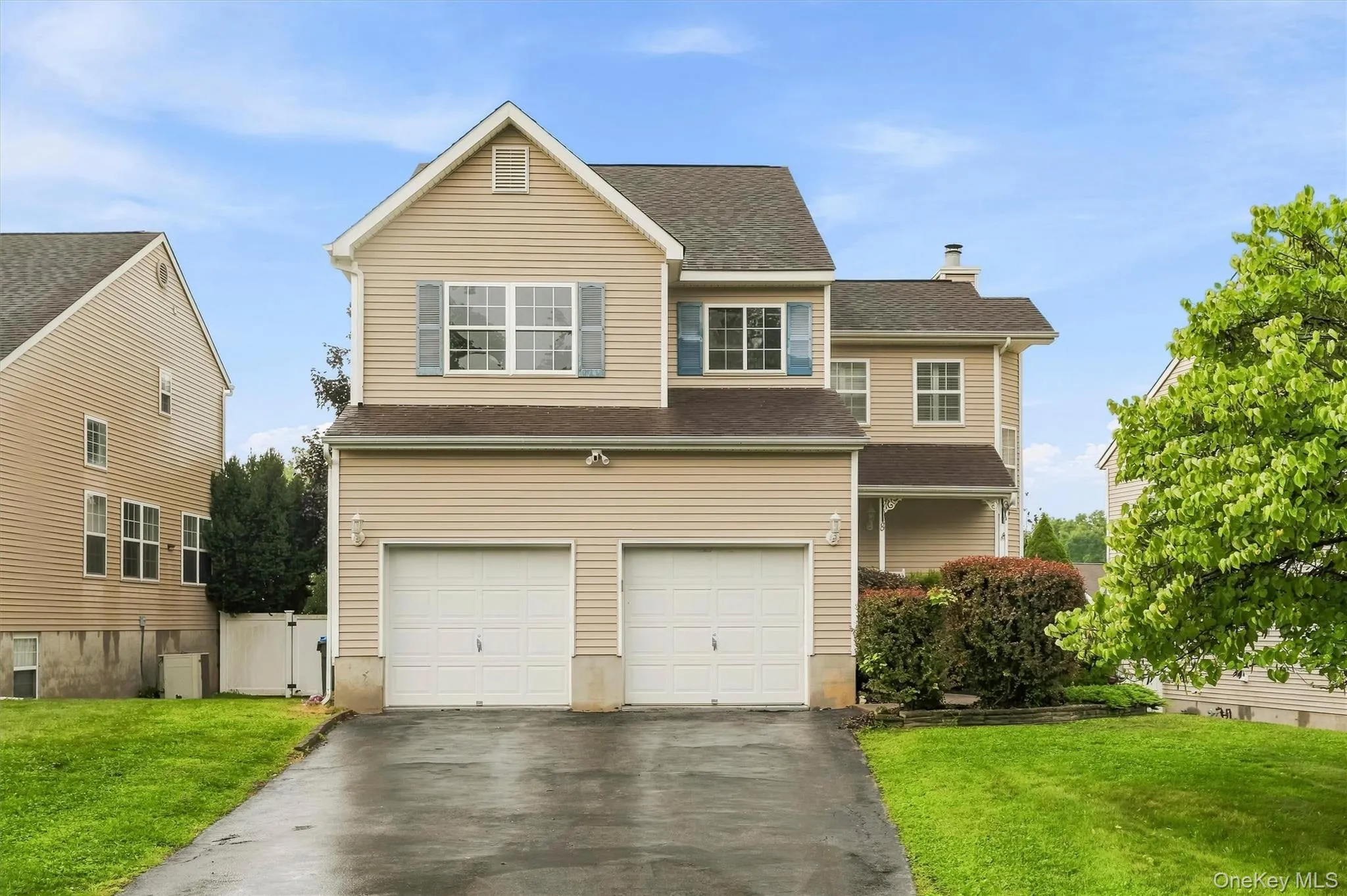 Two-car garage, established front landscaping, and a paved driveway Two-car garage, established front landscaping, and a paved driveway
