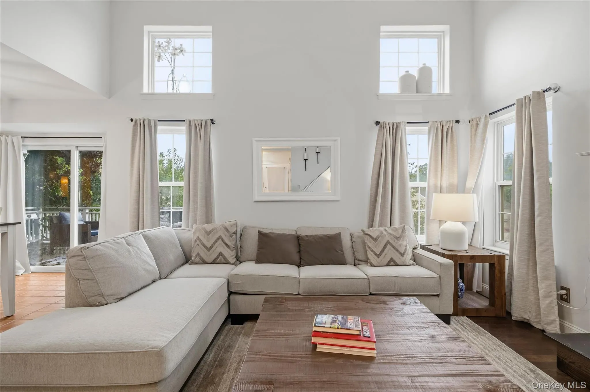 Living space with vaulted ceilings, multiple windows, and sliding glass doors Living space with vaulted ceilings, multiple windows, and sliding glass doors