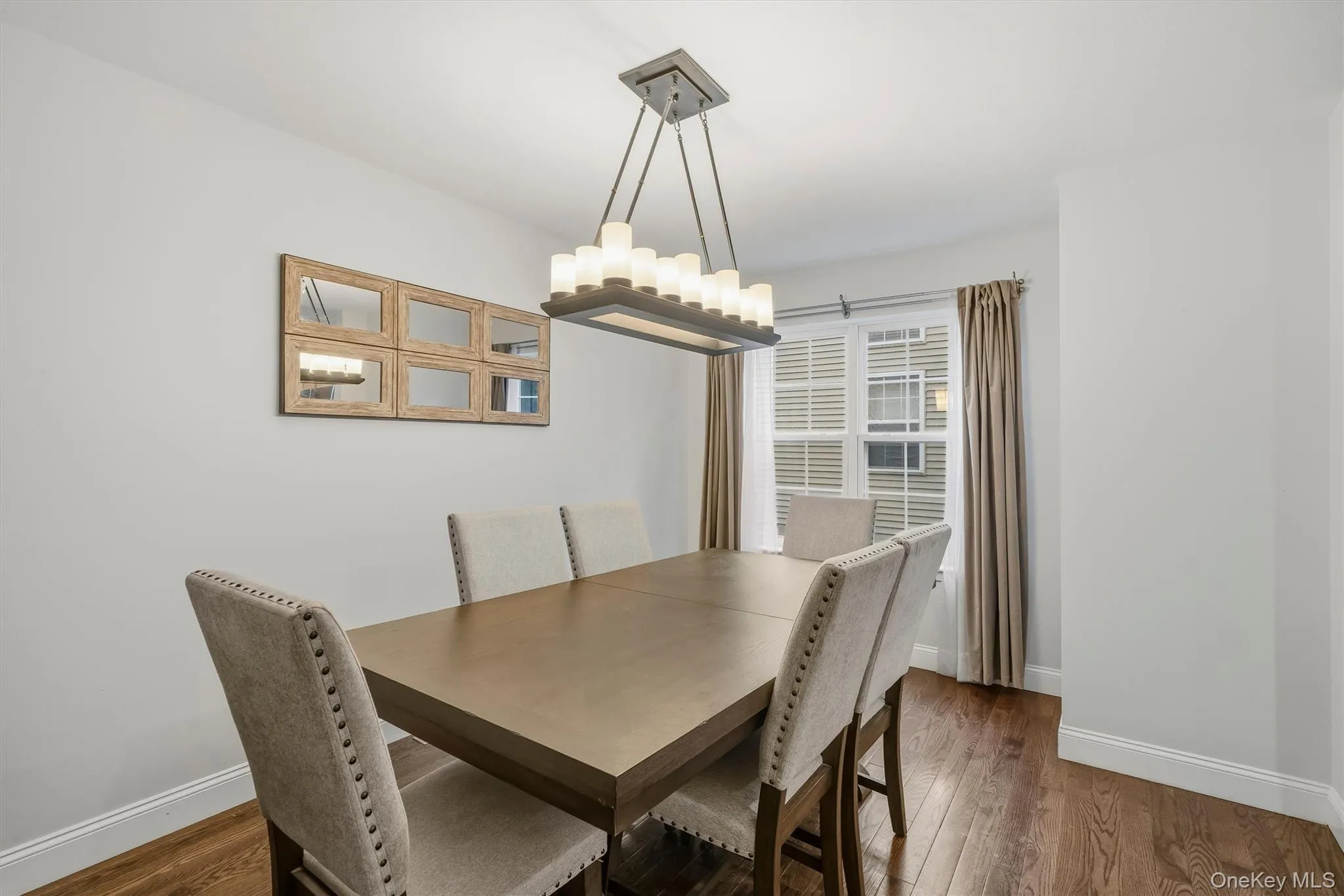 Hardwood flooring, window with blinds, and contemporary ceiling light fixture Hardwood flooring, window with blinds, and contemporary ceiling light fixture