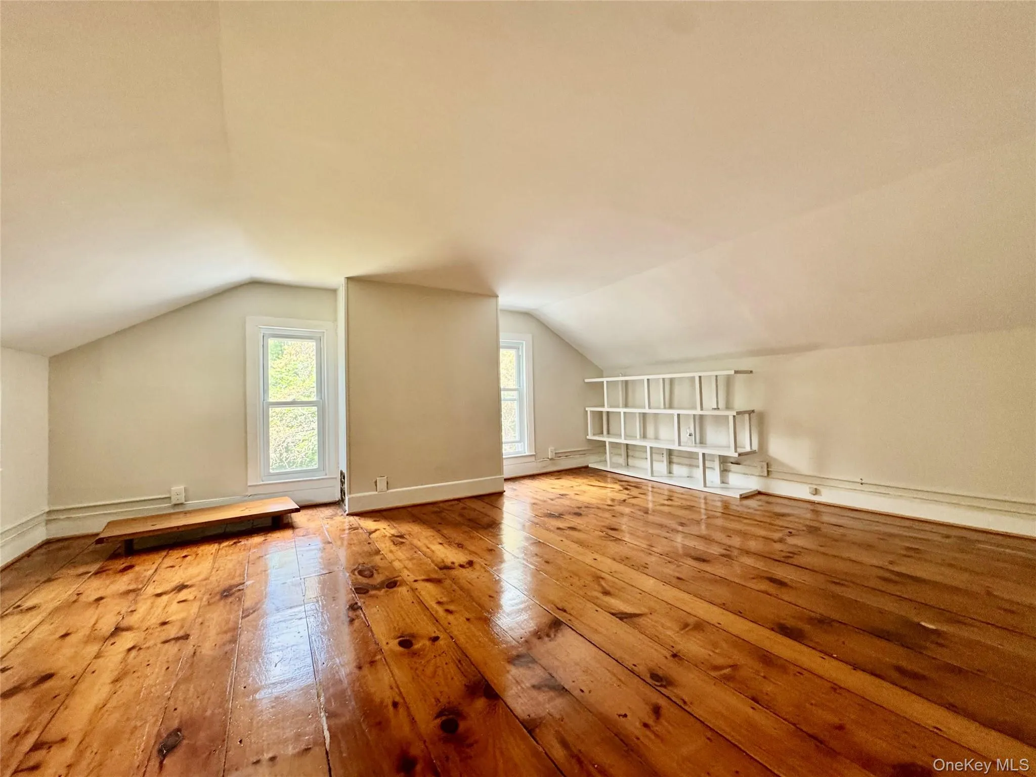 Bedroom with wood-type flooring, vaulted ceiling, and plenty of natural light Bedroom with wood-type flooring, vaulted ceiling, and plenty of natural light