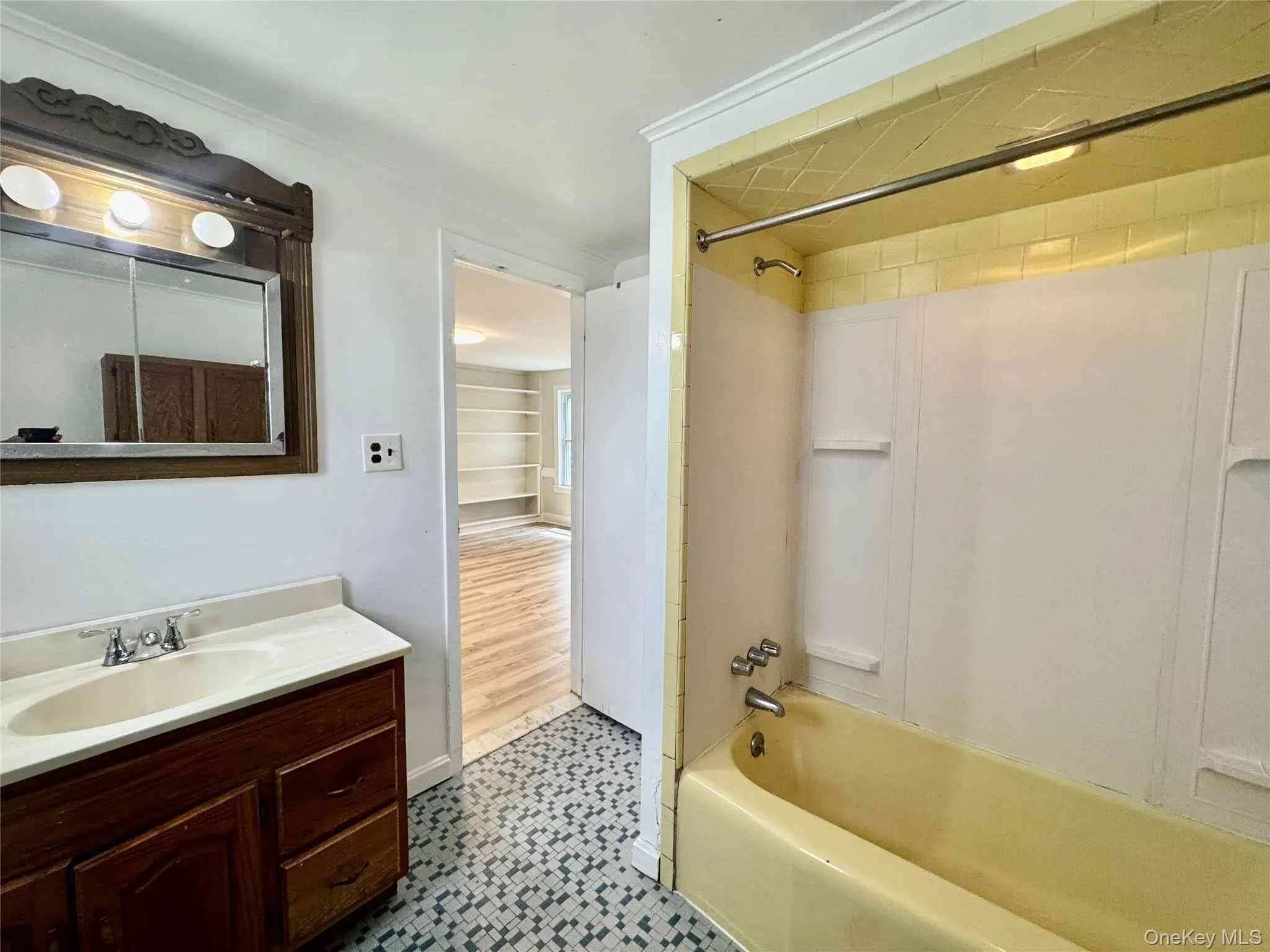 Full bathroom with shower / bath combination, vanity, and tile patterned floors Full bathroom with shower / bath combination, vanity, and tile patterned floors