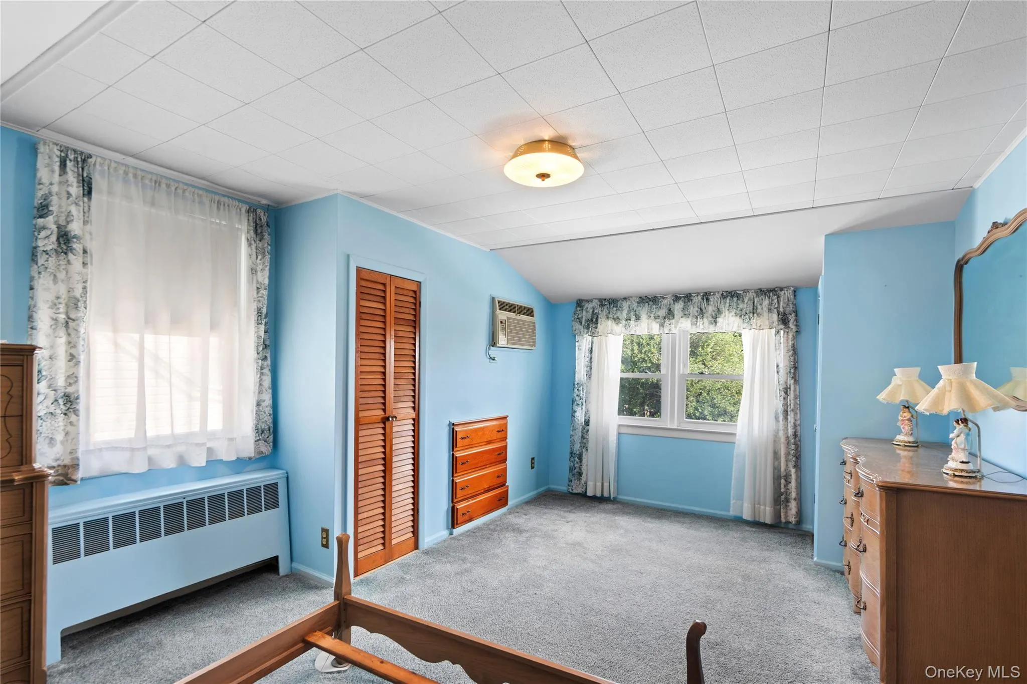 Light blue painted walls, drop ceiling, and wall-to-wall carpeting Light blue painted walls, drop ceiling, and wall-to-wall carpeting