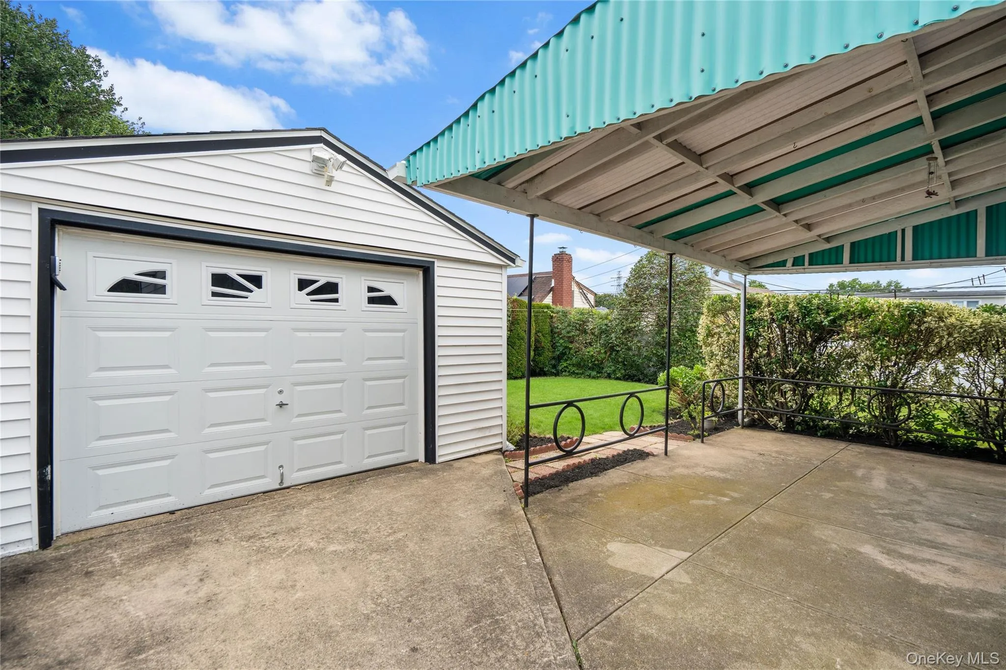 Detached single-car garage with paneling and window inserts Detached single-car garage with paneling and window inserts