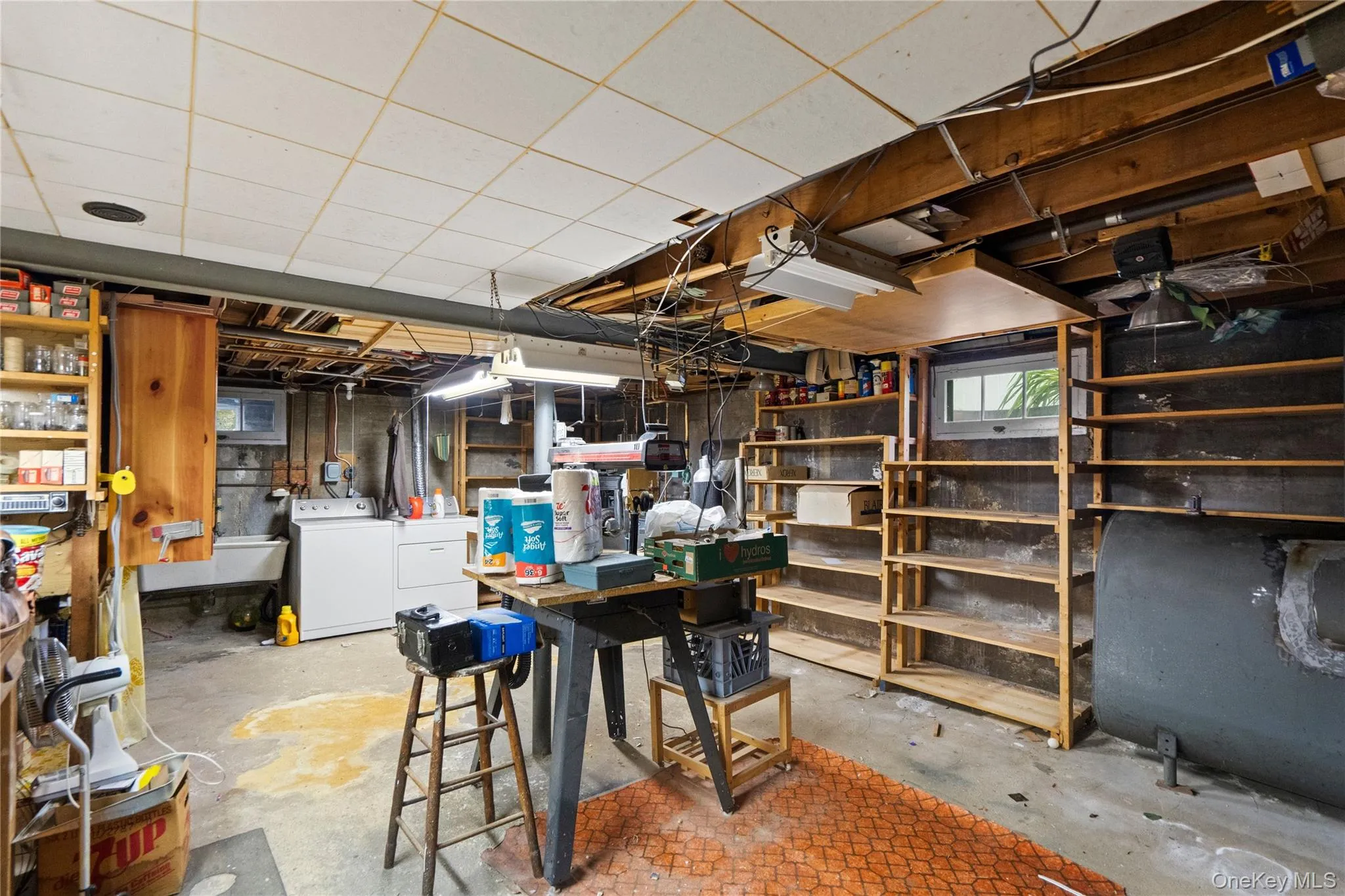 Utility area featuring a laundry sink, washer, dryer, and built-in shelving Utility area featuring a laundry sink, washer, dryer, and built-in shelving